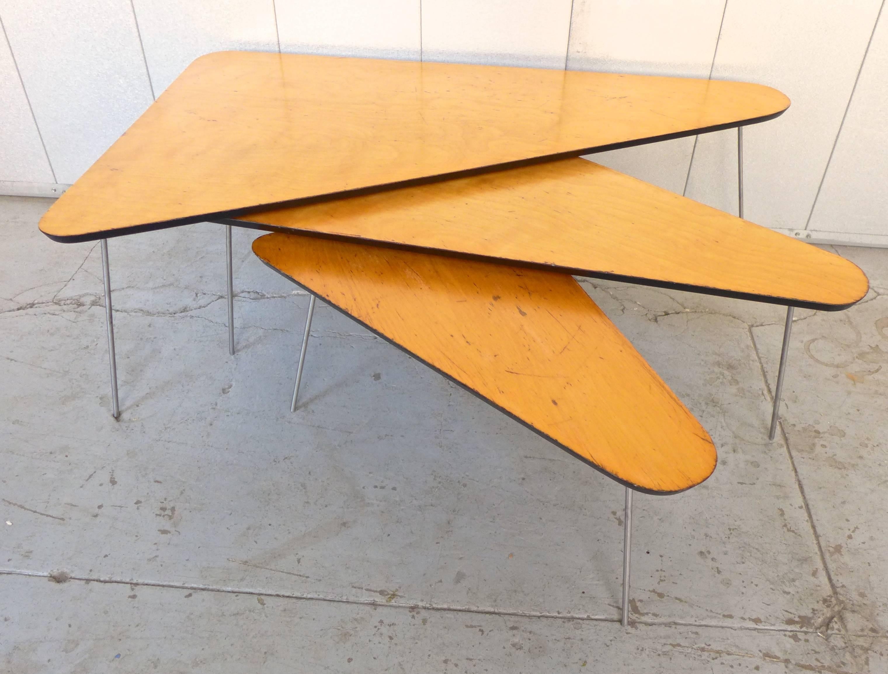 Nest of three triangular tables with rounded beveled edges. Birch tops, cold rolled steel legs. Designed by Joseph Carreiro and produced by Pine and Baker of Cambridge, MA, c. 1950. A native of Cambridge, Carreiro studied at the Massachusetts School