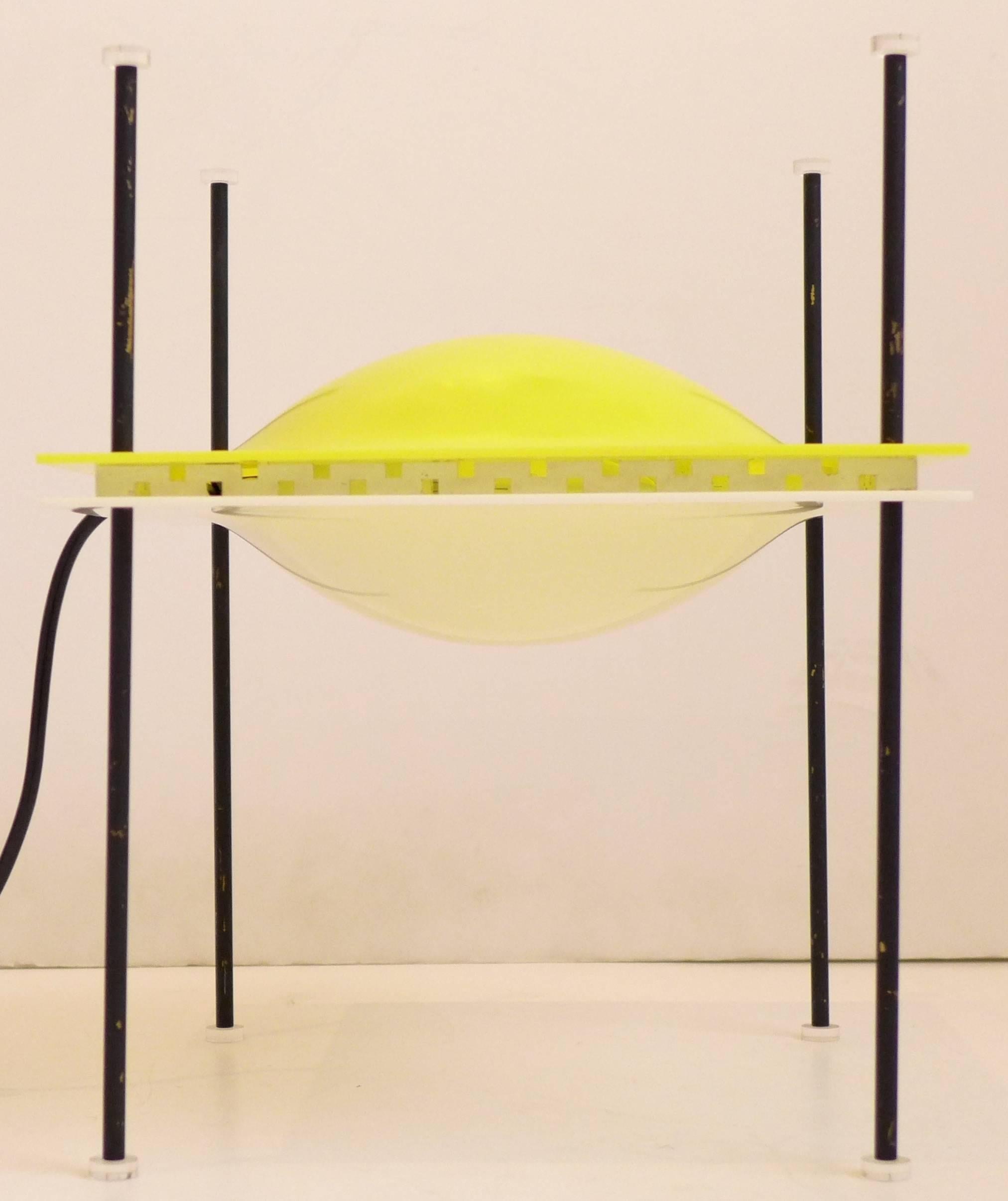 Rare, iconic table lamp of molded perspex plastic with enameled brass and Lucite. Designed by Ettore Sottsass and produced by Arredoluce, c. 1957. This lamp was intended to be adjustable: with the white part up, it diffuses light; with the white