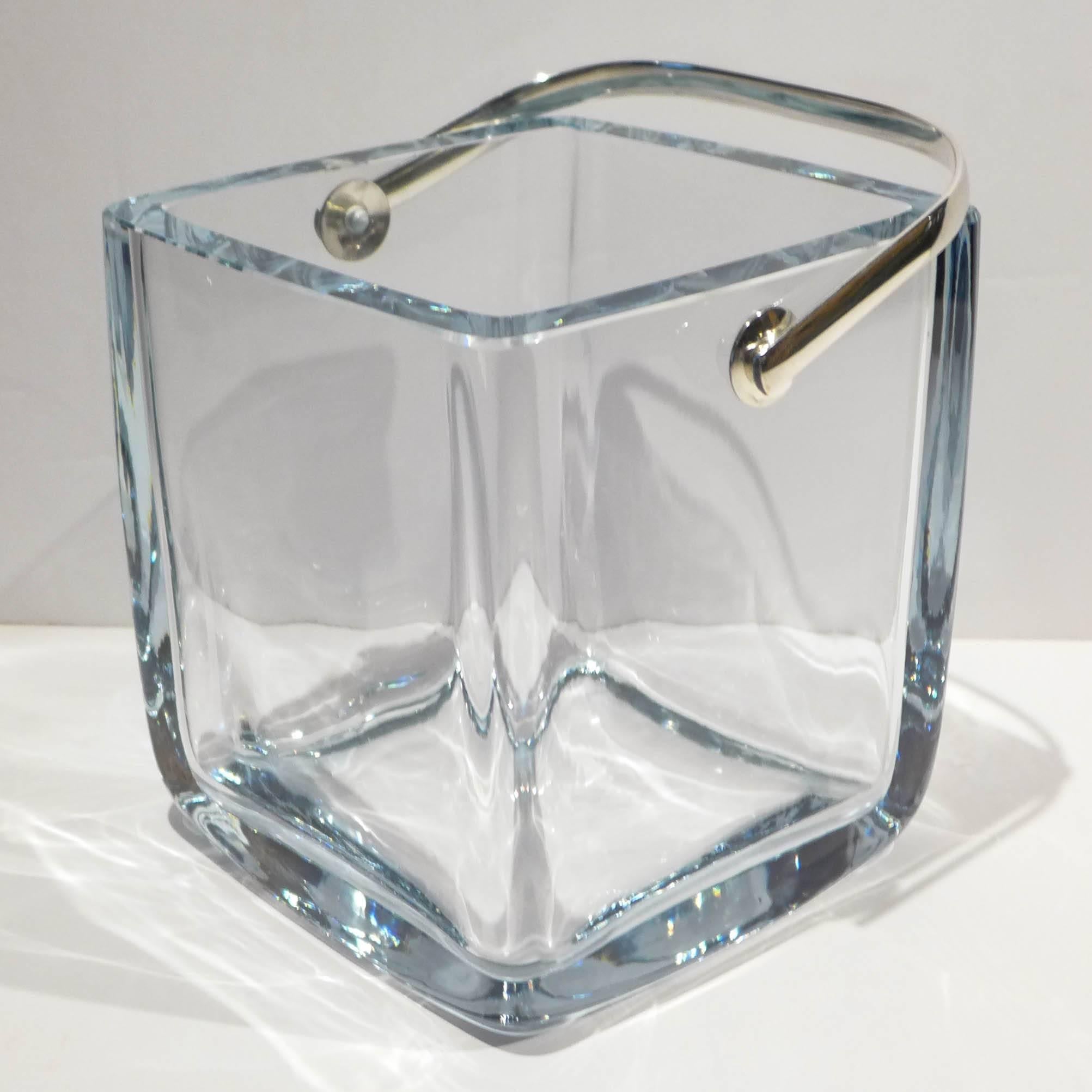 Blue-tinted crystal ice bucket in a rounded-edge rectangular form with a silver-plated handle. A heavy, handsome and well-made item from Cartier, circa 1960s. Incised signature underneath. Measurements do not include handle.