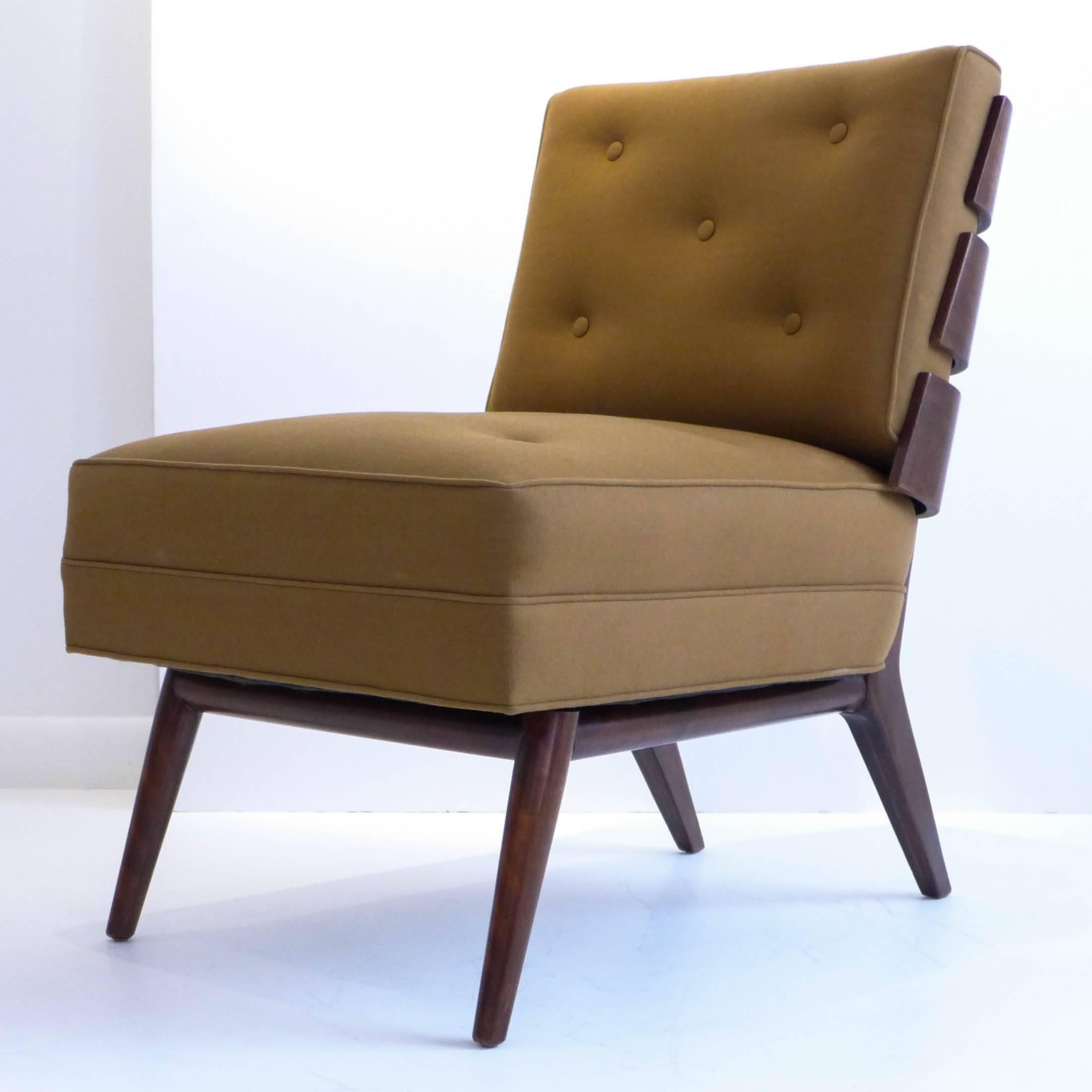 Chic and rare pair of armless lounge chairs in walnut with rakishly angled, steam-bent slat backs, designed by T.H. Robsjohn-Gibbings for Widdicomb Furniture (model #1712), produced circa 1954. Frames refinished; seat and loose back bolster