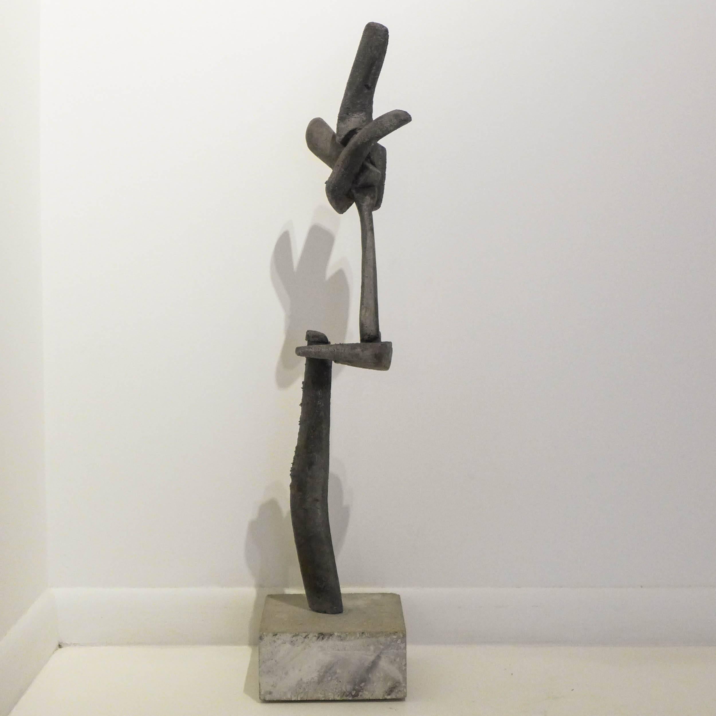 Slender, Brutalist abstract sculpture made of cast and joined aluminum on a cement base. By Kansas City artist and furniture maker Gene Caples (1911-1989). Caples studied at Cranbrook with Julius Schmidt, earning an MFA in 1965. Signed and dated