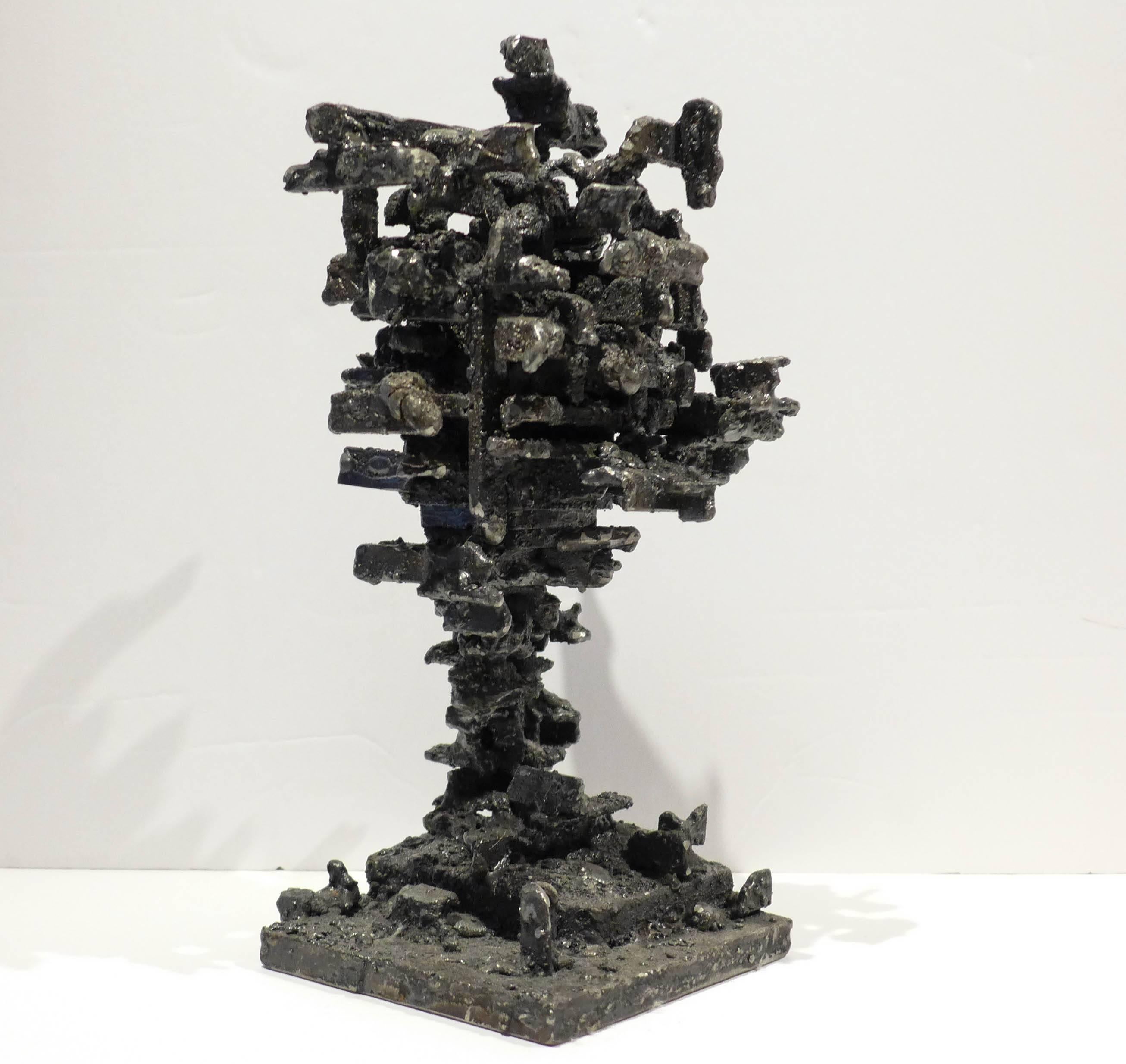 Sculptural box of blackened and polished steel, raised atop a slender column. From the Dwelling series, 2015, by Des Moines artist James Anthony Bearden.
