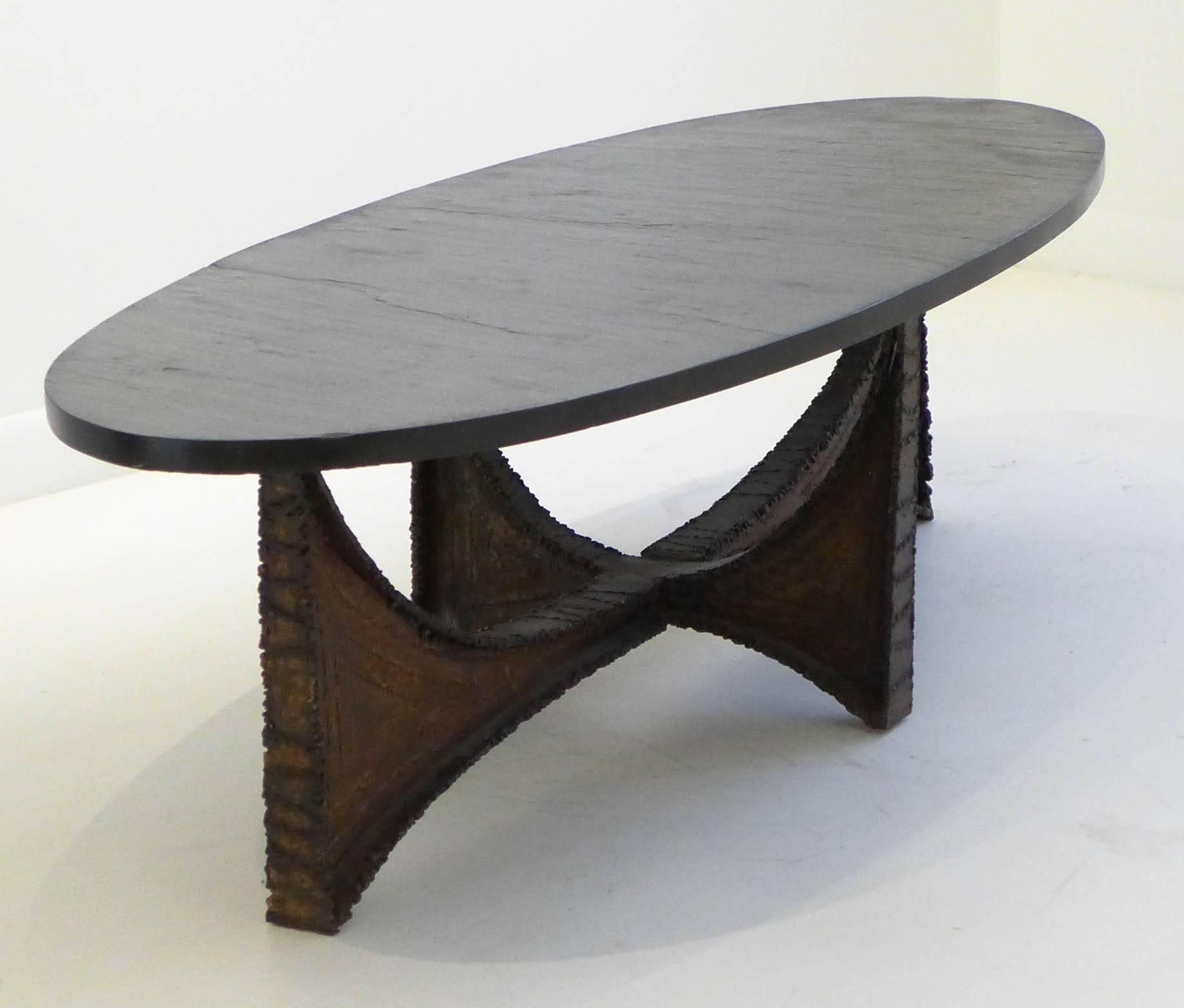Brutalist cocktail table with a welded, patinated and cantilevered steel base and an oblong textured slate top. A rare Paul Evans design produced at the Paul Evans studio, c. 1970. Unmarked. For similar examples, see Wright, 24 June 2010 Lot 110 and
