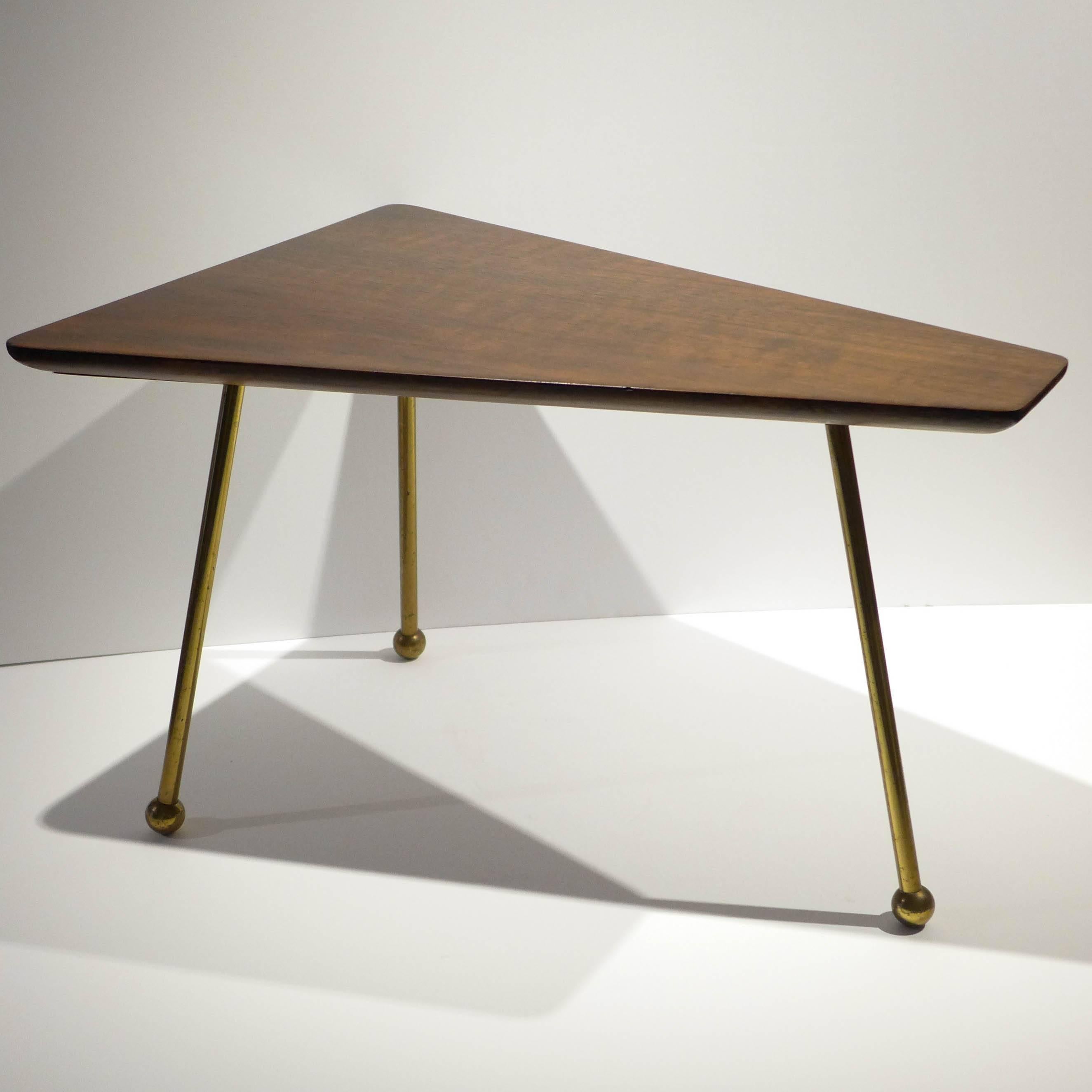 Rare trapezoidal side table with walnut top with rounded chamfered edges and solid brass demountable legs culminating in ball feet. Designed and produced by Martin Freedgood, circa 1951. Freedgood was a largely self-taught designer who studied