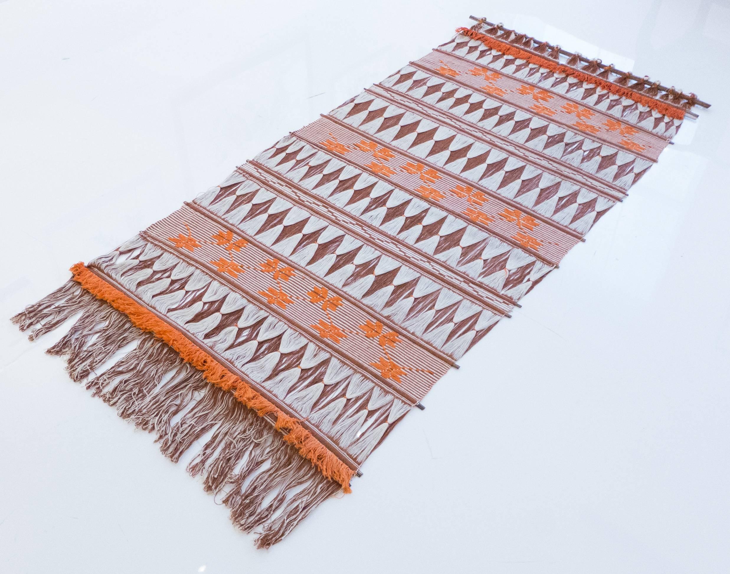 Hanging textile of woven wool with horizontal wooden slats; made in Scandinavia, circa 1960s.