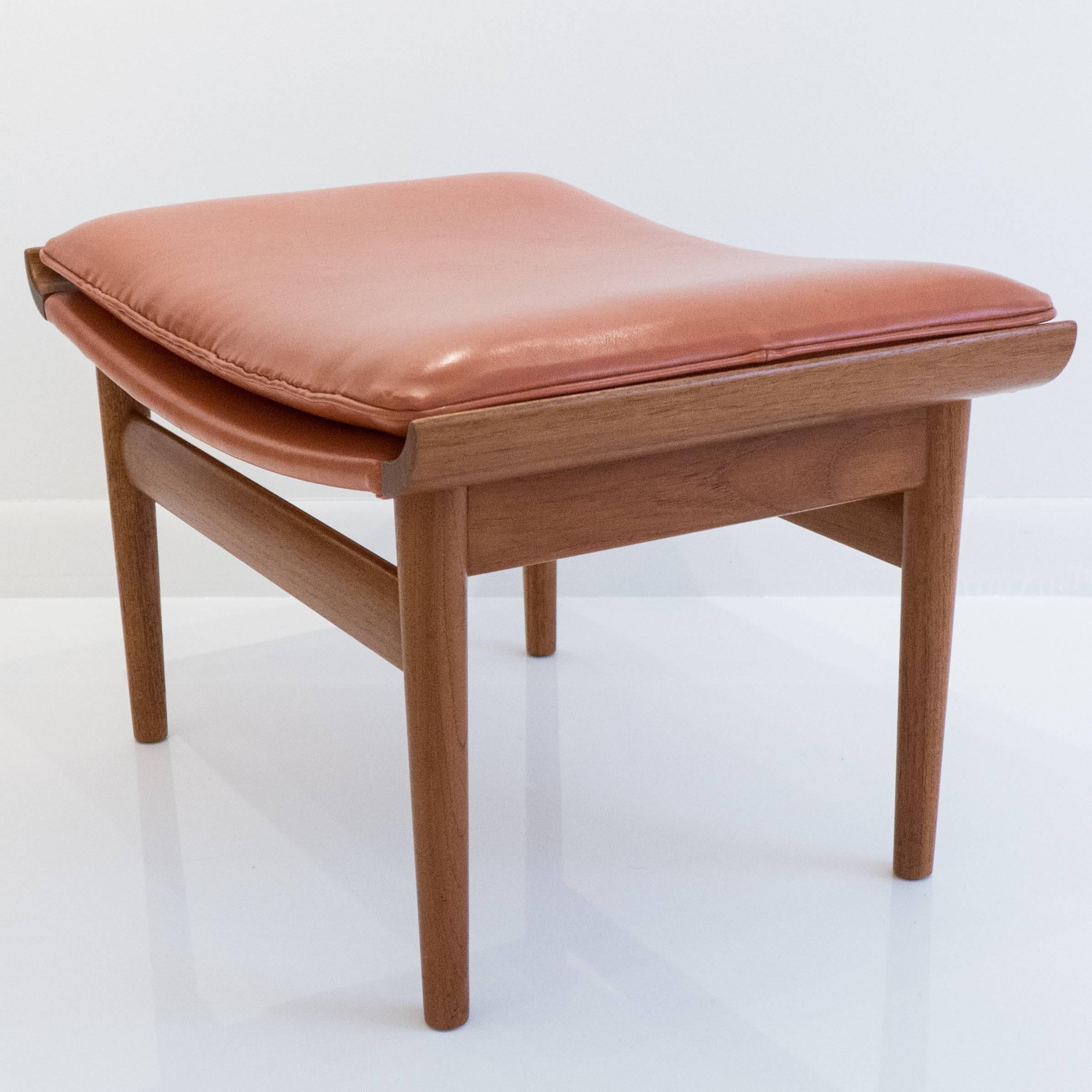 Teak ottoman with leather cushion designed by Finn Juhl and produced by France & Sons, circa 1960s. This ottoman was intended as a counterpart to his 
