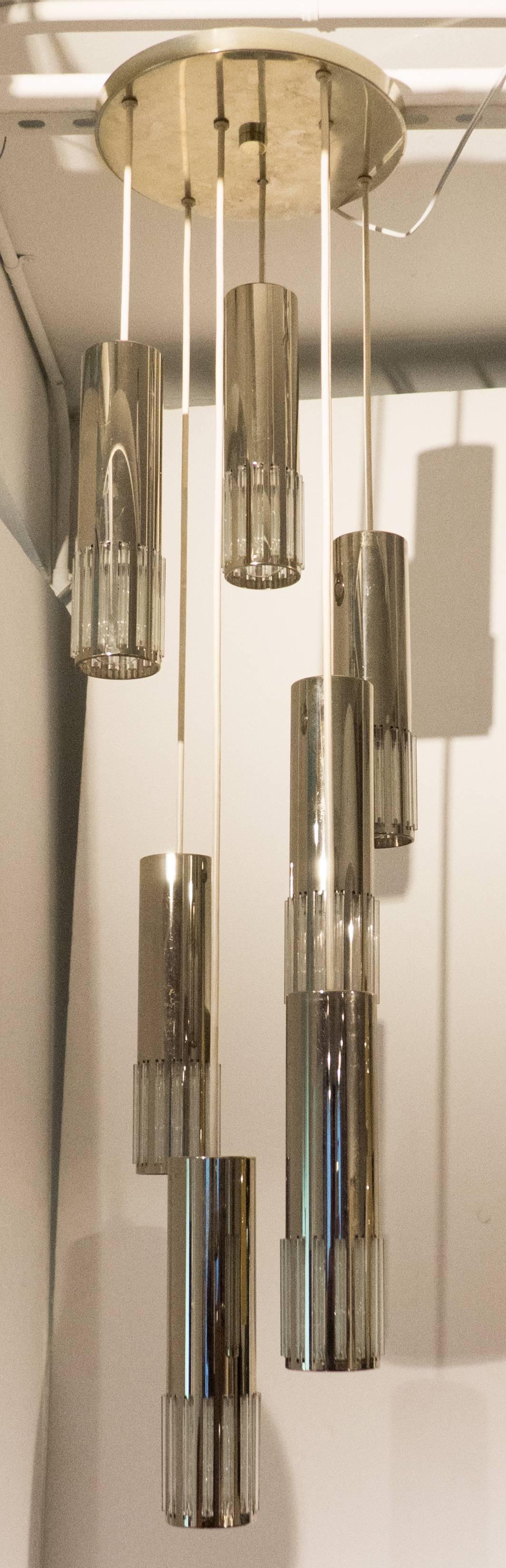 Hanging fixture consisting of seven cascading chrome cylinders with crystal diffusers and the original chrome ceiling disk. Made in West Germany, circa 1960s for Koch & Lowy. Measurements are of the height as displayed, and the diameter of the