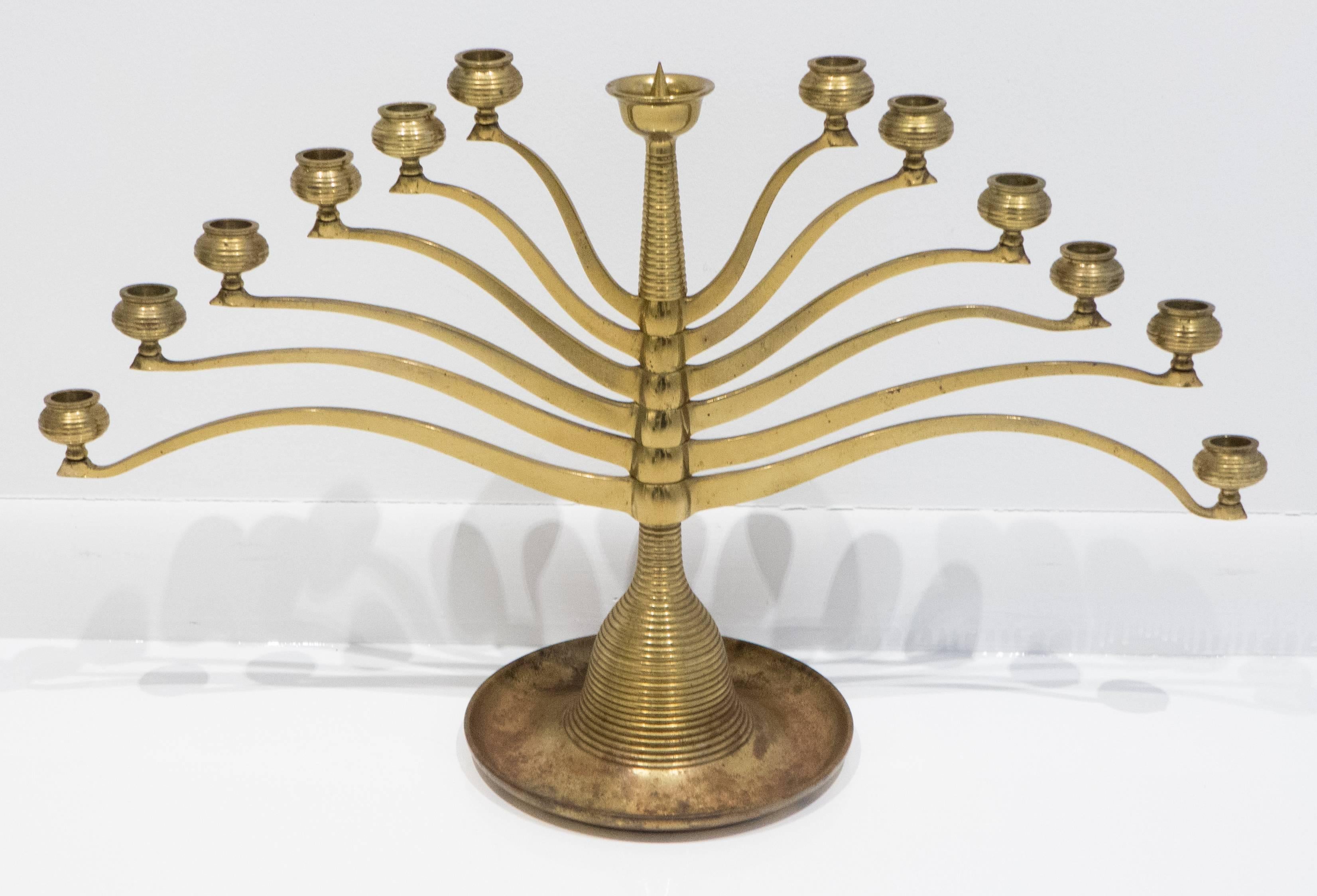 Brass candelabra with six pivoting arms accommodating thirteen candles. Made by the Anderson Foundry in Chicago, circa 1910. Modeled on an iconic Jugenstil design by early modernist master Bruno Paul. Impressed mark underneath.