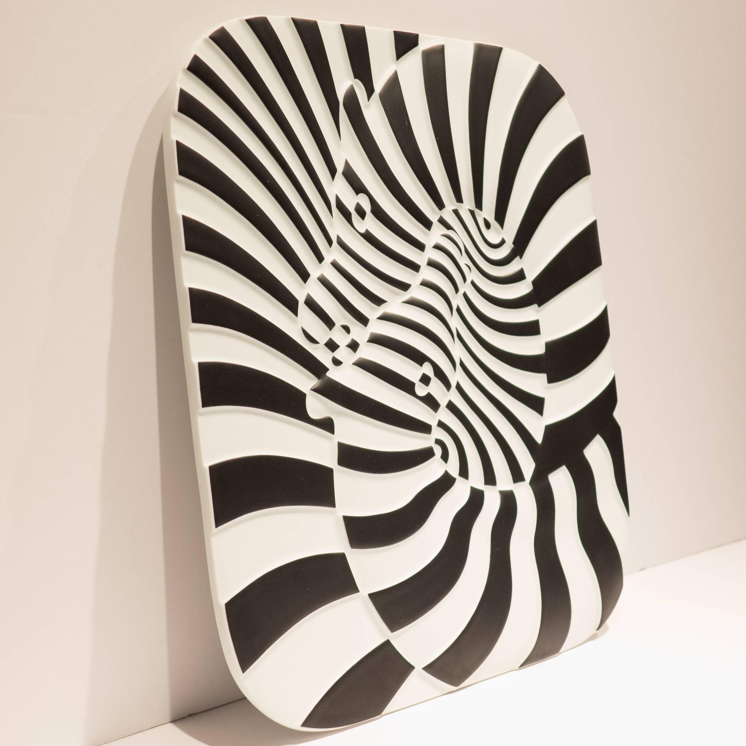 Op Art plaque or wall sculpture of two zebras in molded and painted porcelain. 
The wavy surface of the plaque emphasizes the Op Art effect. A 1977 design by Victor Vasarely for Rosenthal Studio Line, produced in a limited edition of 3,000 of which