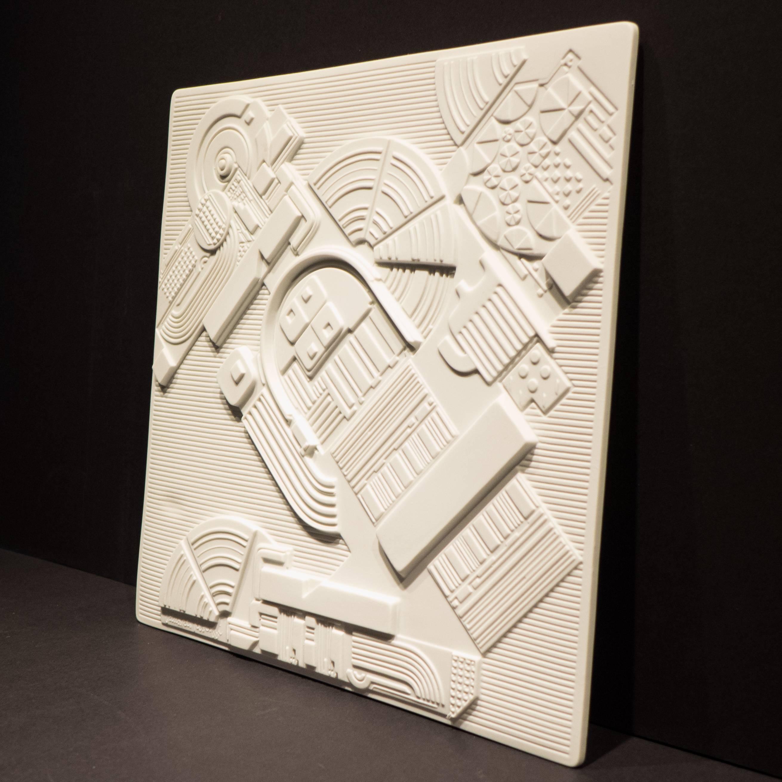 Porcelain wall sculpture or plaque in high relief by Pop Art Pioneer Eduardo Paolozzi. Produced by Rosenthal Studio Line in 1978 in a limited edition of 3,000 of which this is number 2852. The Jahresteller series consisted of an annual collaboration