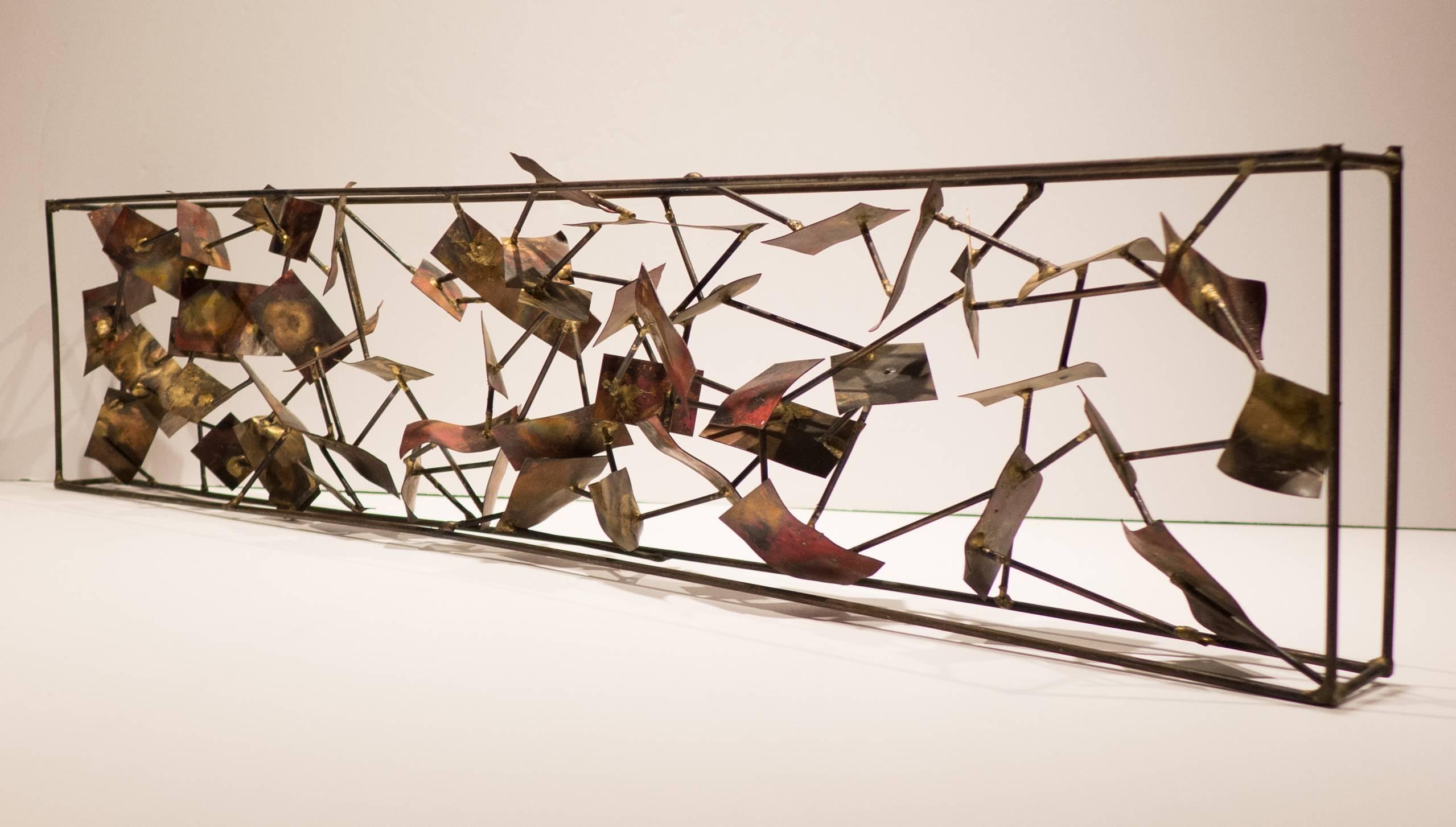 Hand collaged sculpture consisting of multiple acid-washed metal panels attached to thin metal rods, set into an open rectangular metal frame.
A different presentation front and back. Fluidly abstract in a manner similar to Bertoia's panel