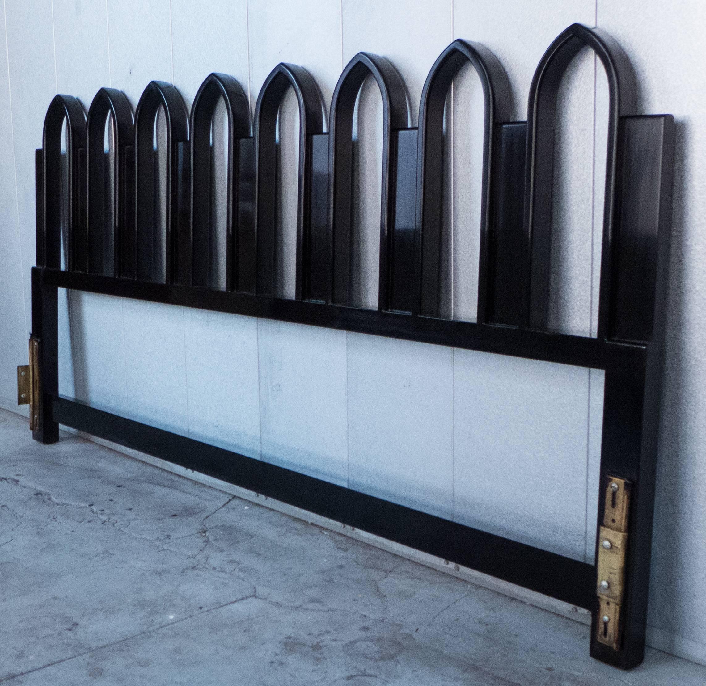 King-size headboard in dark mahogany with a row of Gothic arches. Designed and produced by Harvey Probber. With the original brass fittings for a universal frame, and a copy of the original receipt from Probber dated 1962. The measurement from the