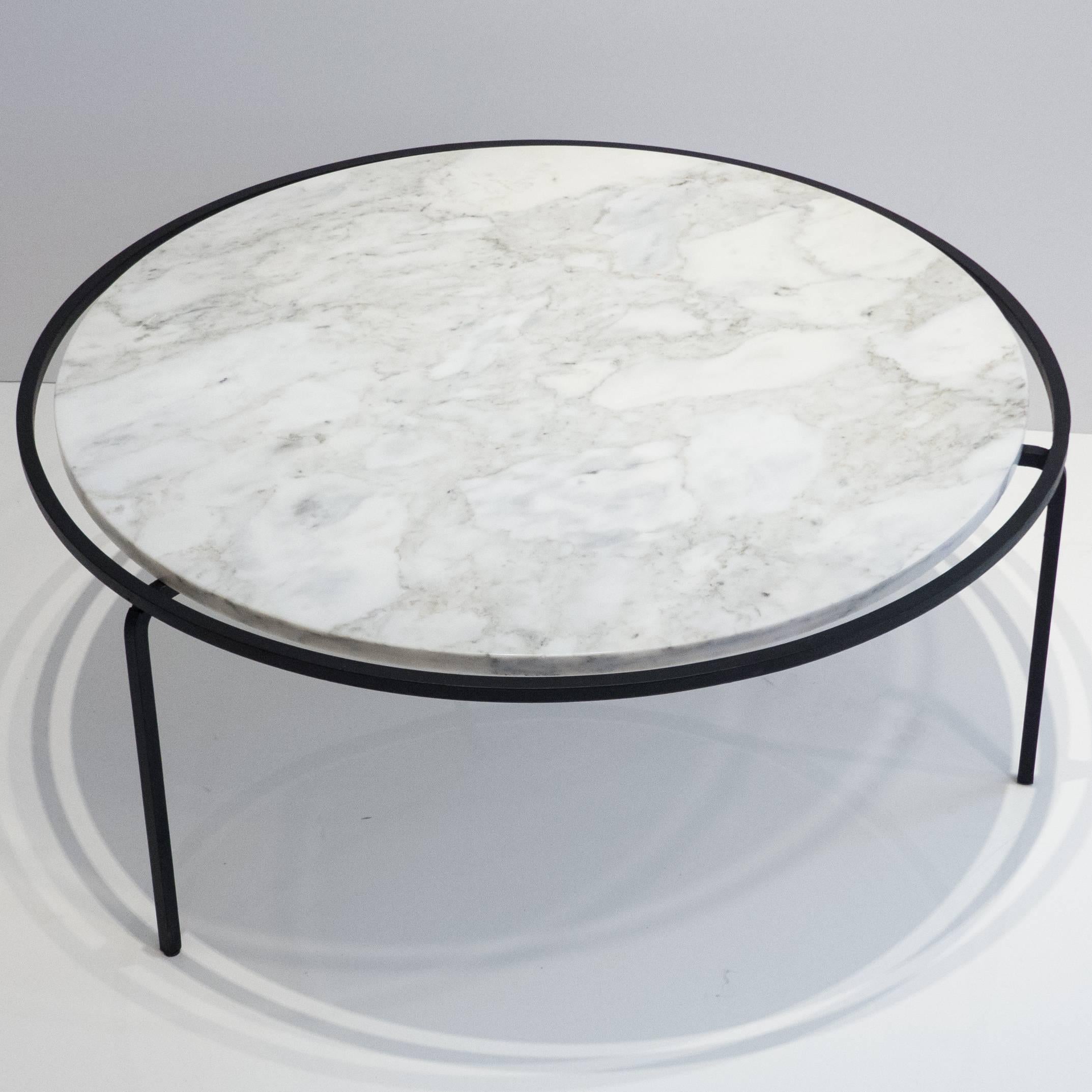 Circular three-leg cocktail table with inset Italian Carrara marble top and black square steel base. A rarely seen design by Allan Gould, produced by Reilly-Wolff Associates of New York City, circa 1952. The floating top was also offered in glass,