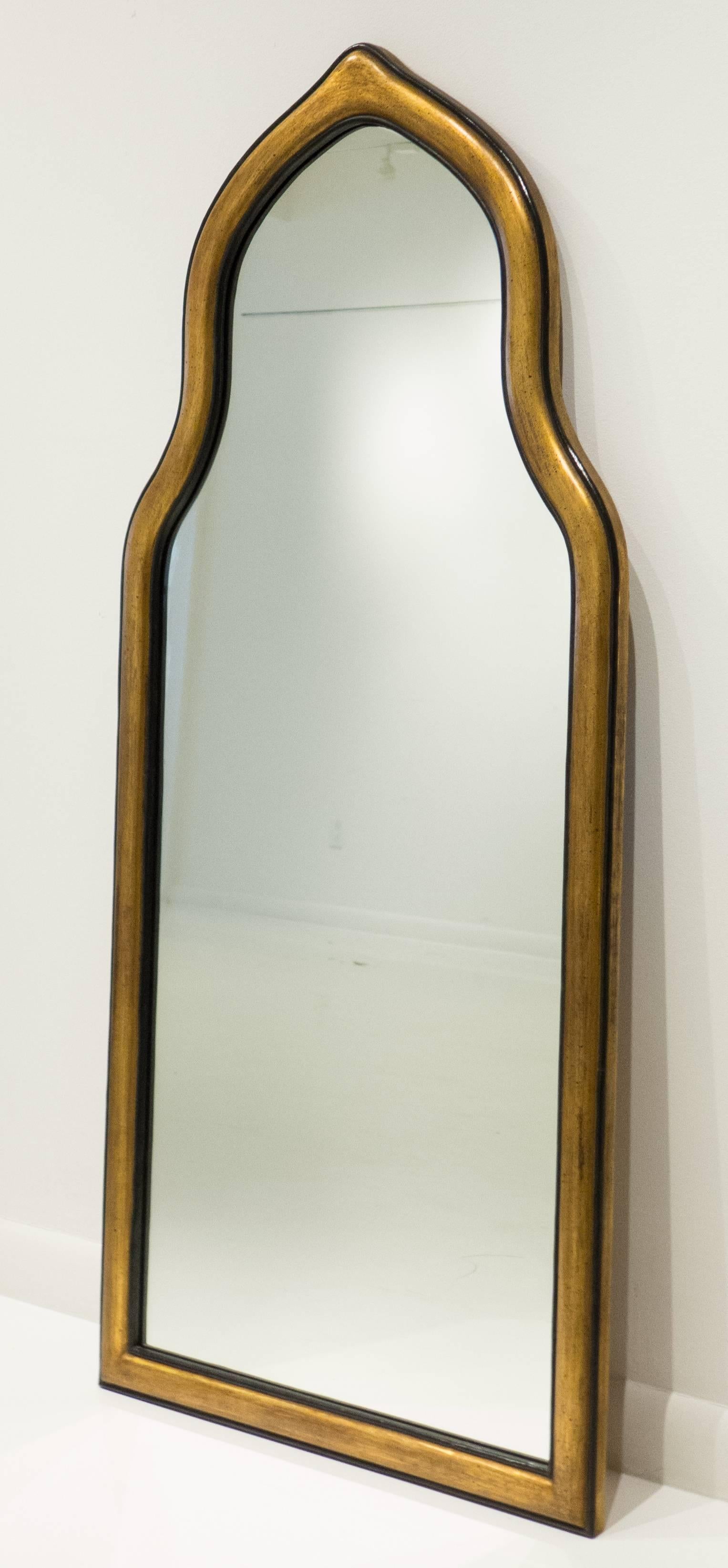 Handcrafted pier or wall mirror with a Moorish arch. Carved wooden frame with patinated gilt gesso and paint. Made by Friedman Brothers, the venerable New York City firm, circa 1950s. 52 inches tall. In excellent condition, still with the original