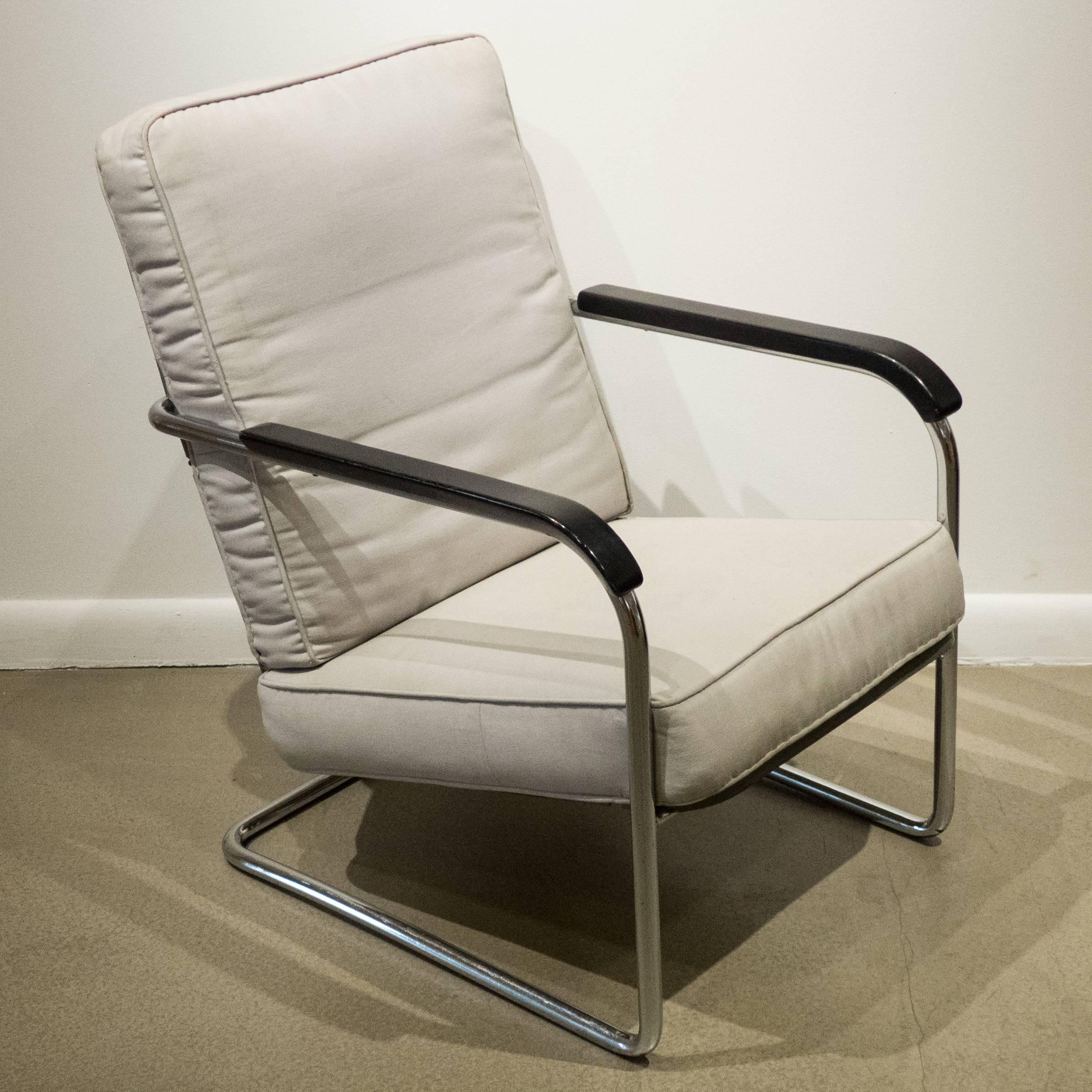 High-back armchair with a cantilevered tubular chrome frame with gray-painted flat and angled steel seat and back and steel coils and painted wooden armrests. Designed by Werner Max Moser and produced by Embru Werke/Wohnbedarf, circa 1934. The loose