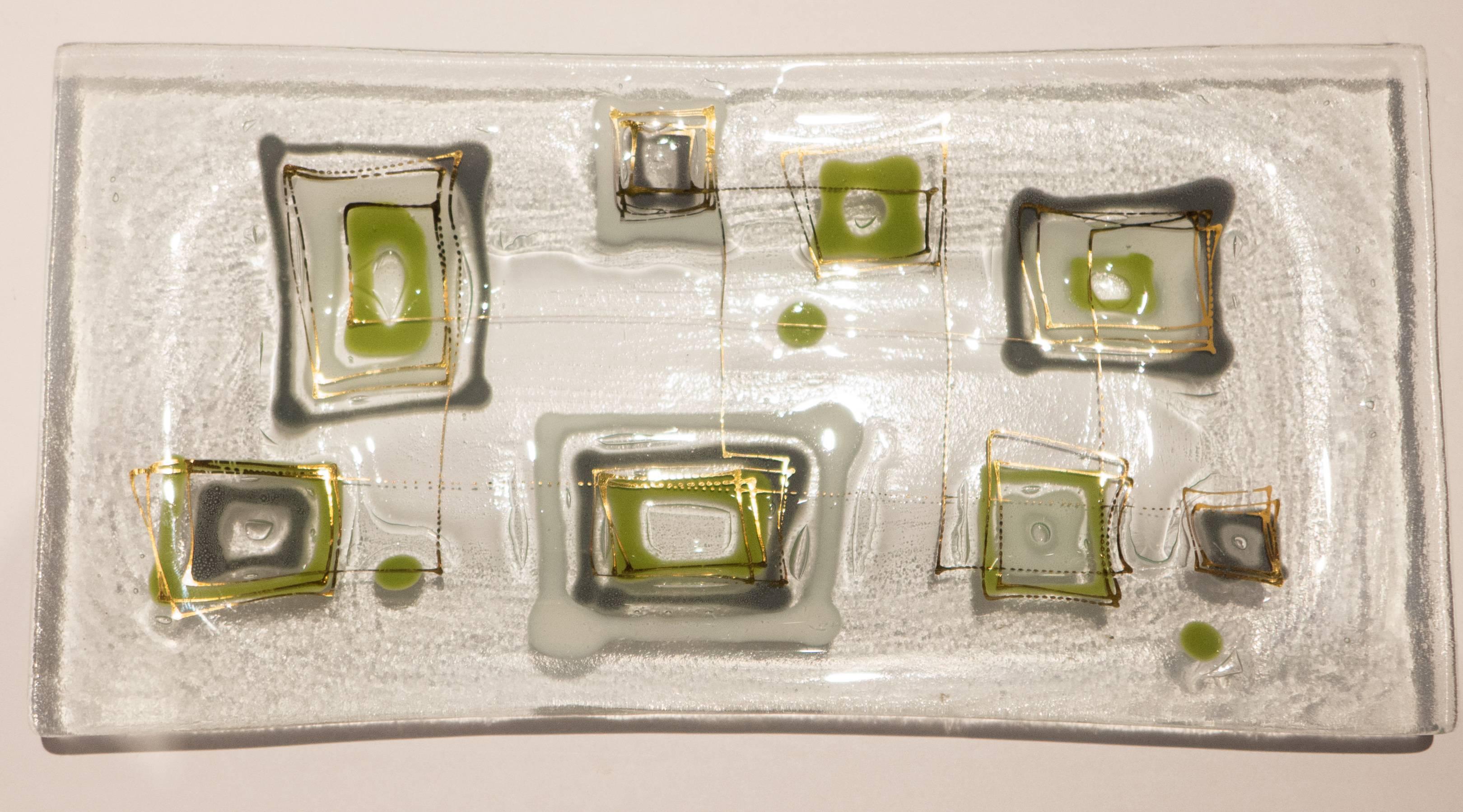 Rectangular fused glass dish with recessed bottom and abstract motif in tinted glass matrix by Frances and Michael Higgins. With the needle-etched signature and figurative cartouche, dating the piece to circa 1951-1957.