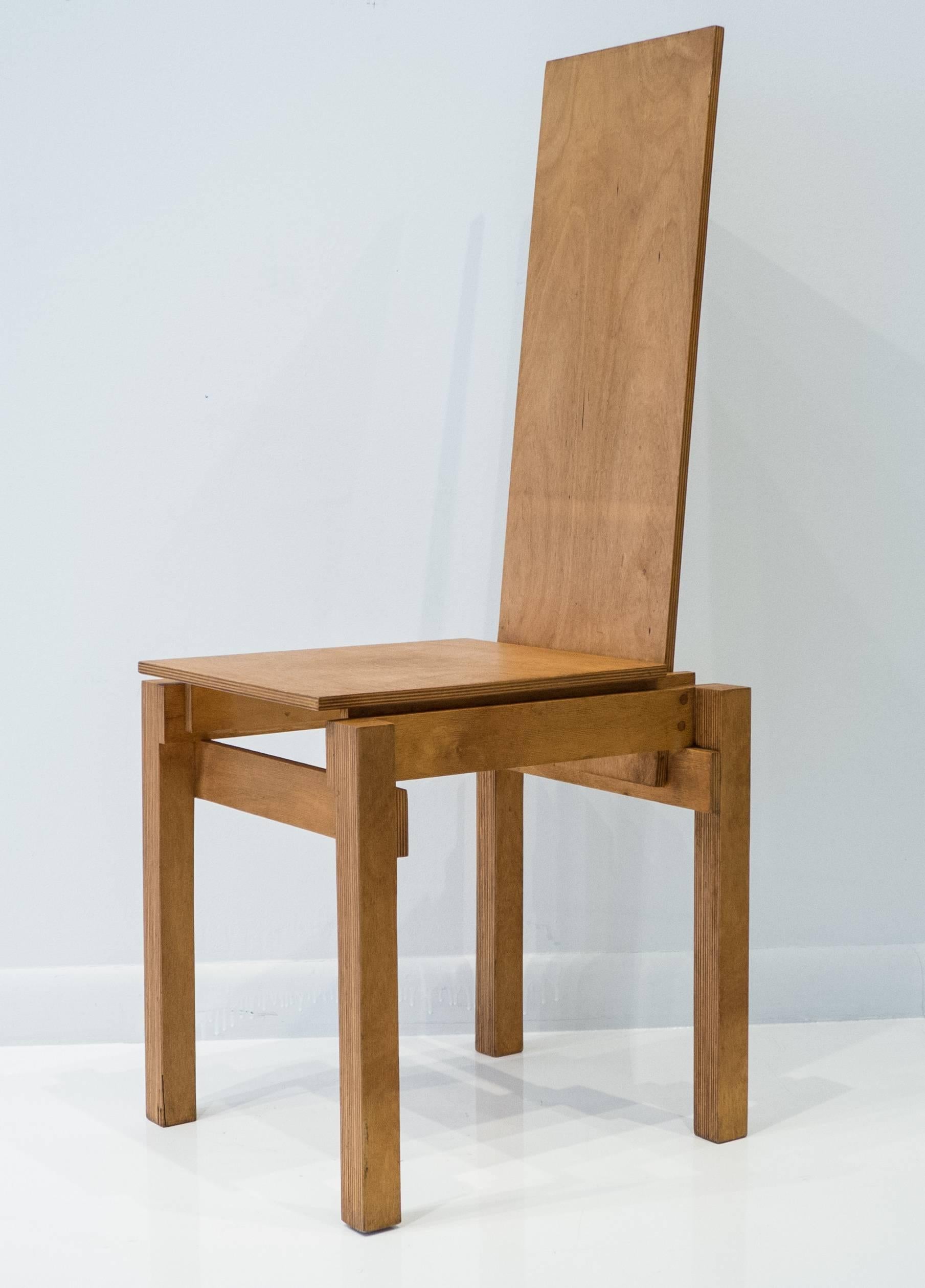 High-back neo-constructivist chair composed of multiple planes of cut and laminated birch plywood, with mortise and tenon joinery attaching the side rails to the seat back. A craft studio homage to Gerrit Rietveld, made circa 1970s, likely in the