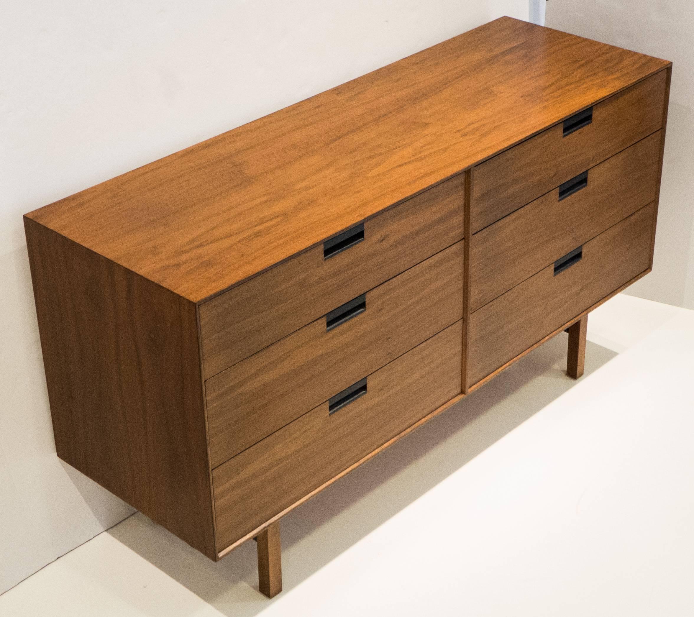 Double chest of drawers in walnut with carved ebonized pulls and ebonized stretchers. A handsome, well-made, and relatively scarce piece with nice details designed by Milo Baughman and produced by Arch Gordon, circa 1959. Oak and mahogany secondary