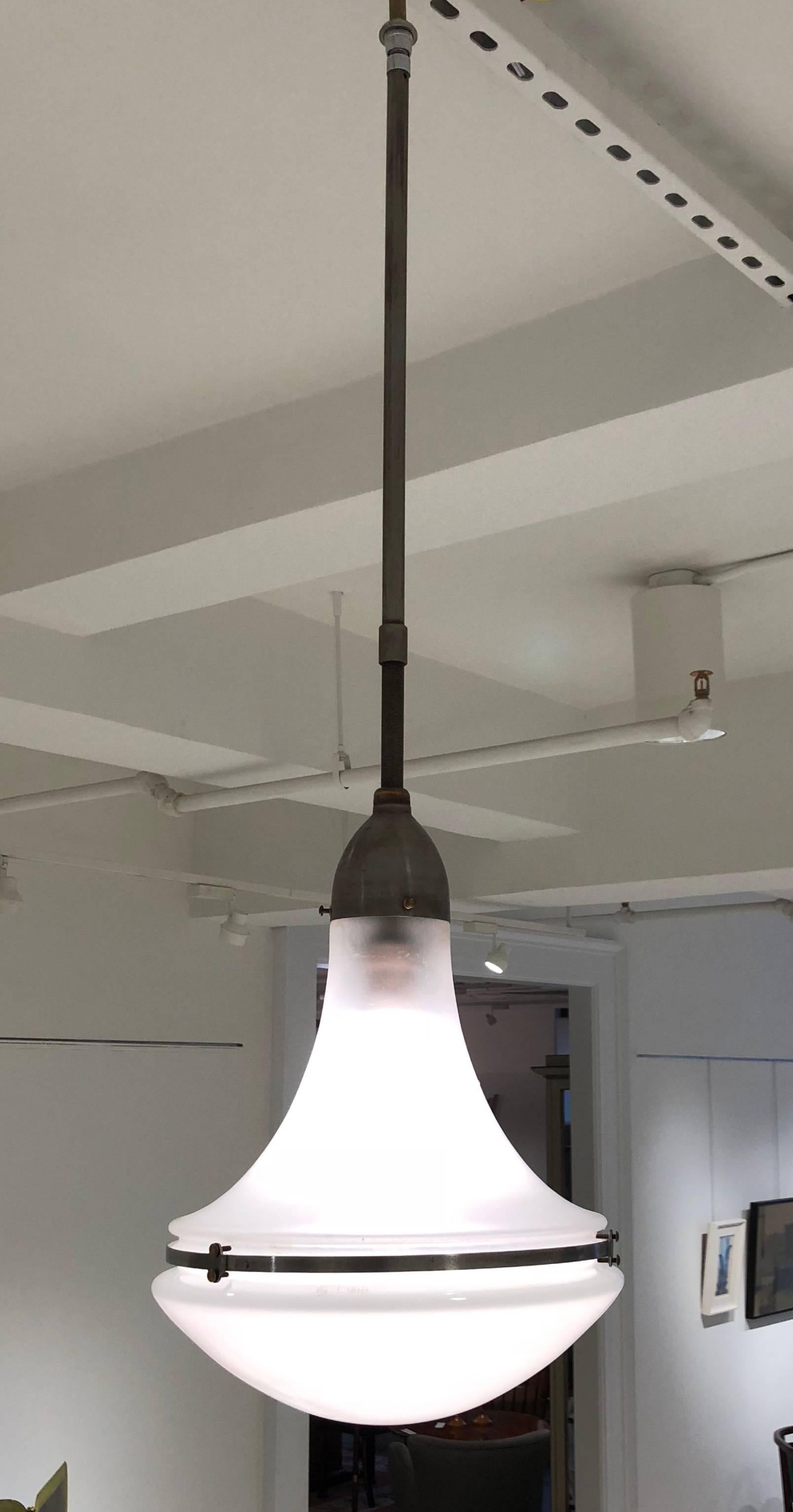 Pendant fixture with frosted glass upper section and opaline glass bottom section, designed by Peter Behrens and produced by Siemens, Germany, circa 1920. With original fittings, including the metal canopy. Measurements are of the fixture only; top
