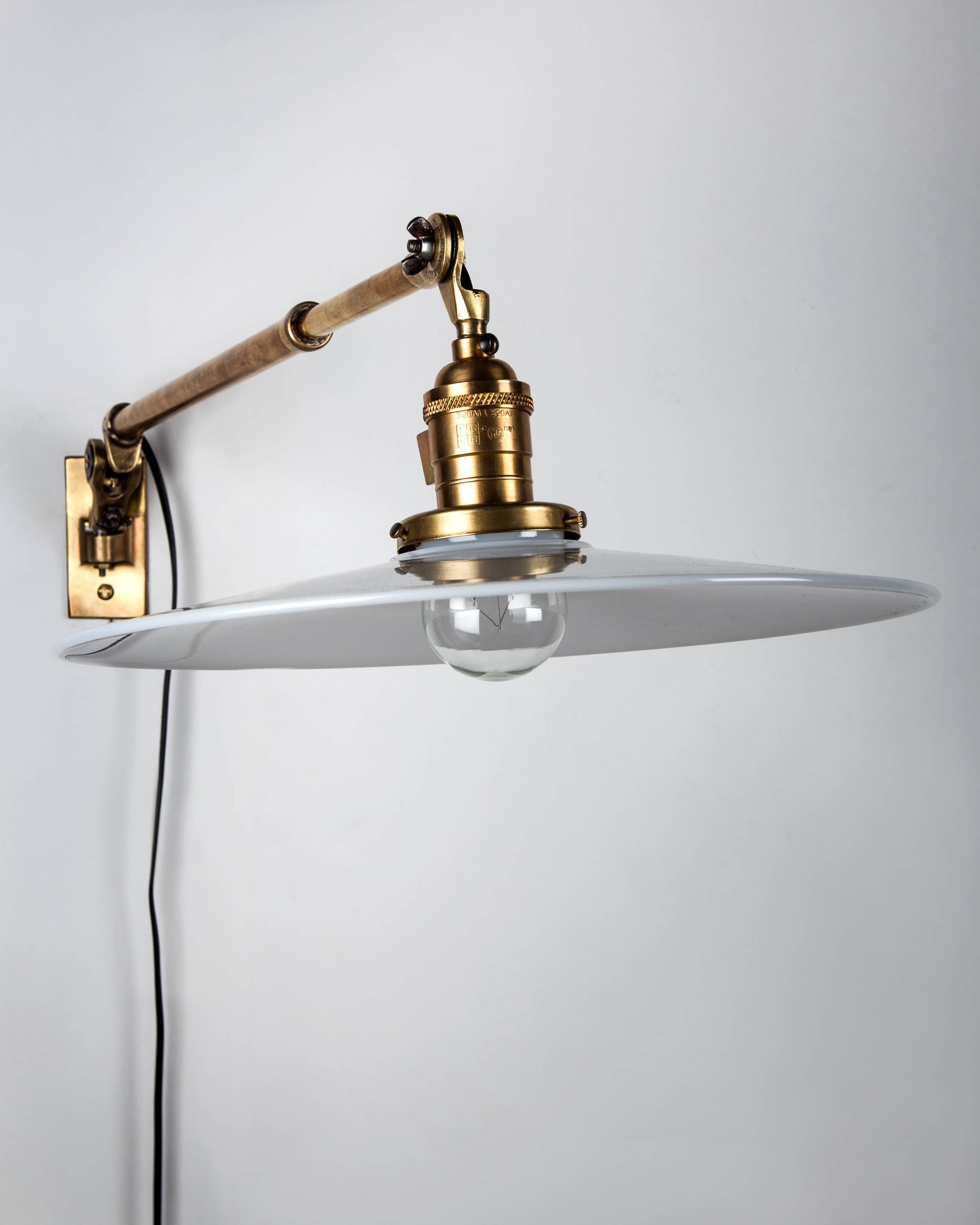 AIS3048
A near pair of telescoping swing arm sconces with a unique vertical pivot as well as right to left rotation, in their original aged brass finish. Having contemporary flat opal glass shades. Signed by the Worcester, Massachusetts maker O. C.
