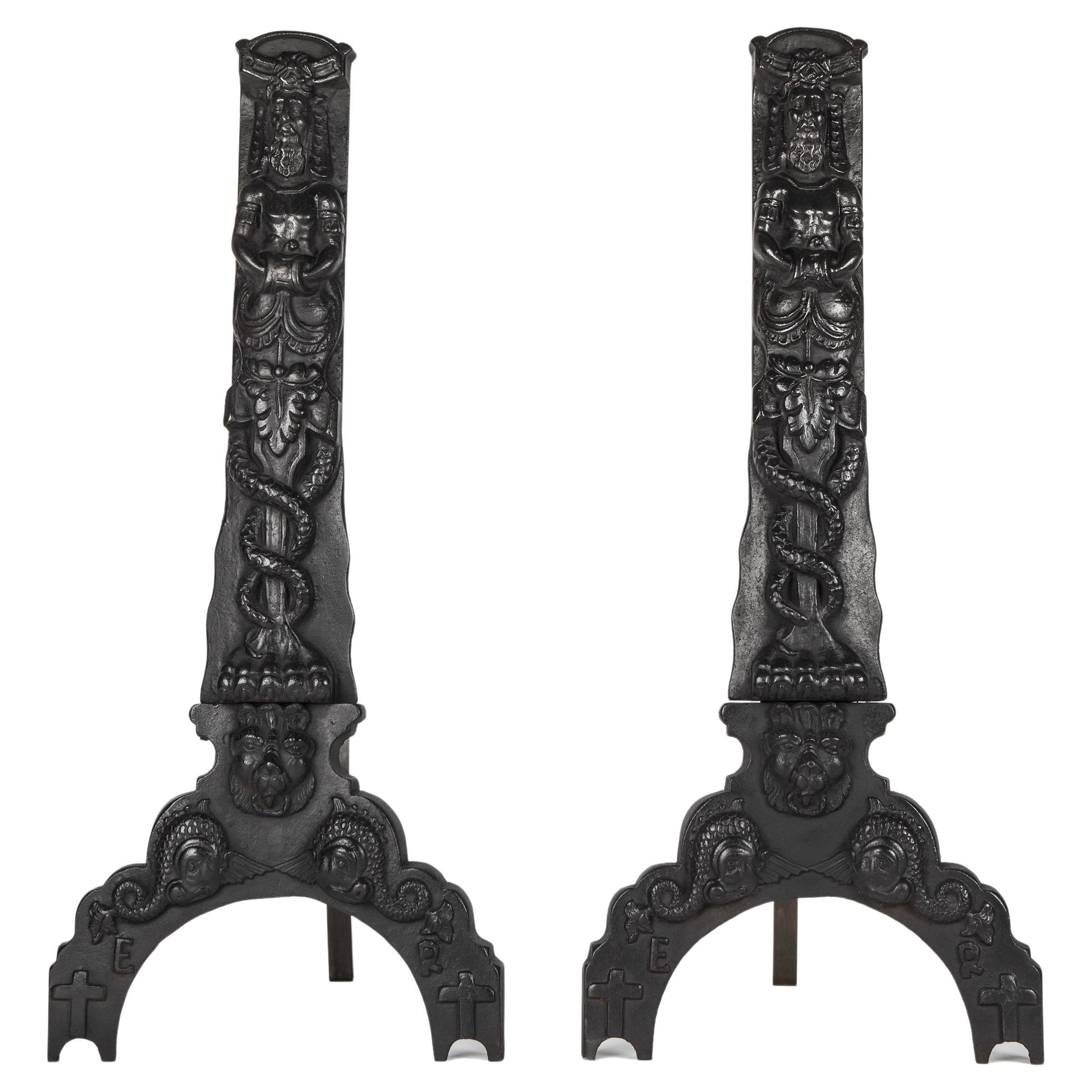 1920s Black Cast Iron Andirons with Figures of a Hybrid Atlas over a Caduceus For Sale