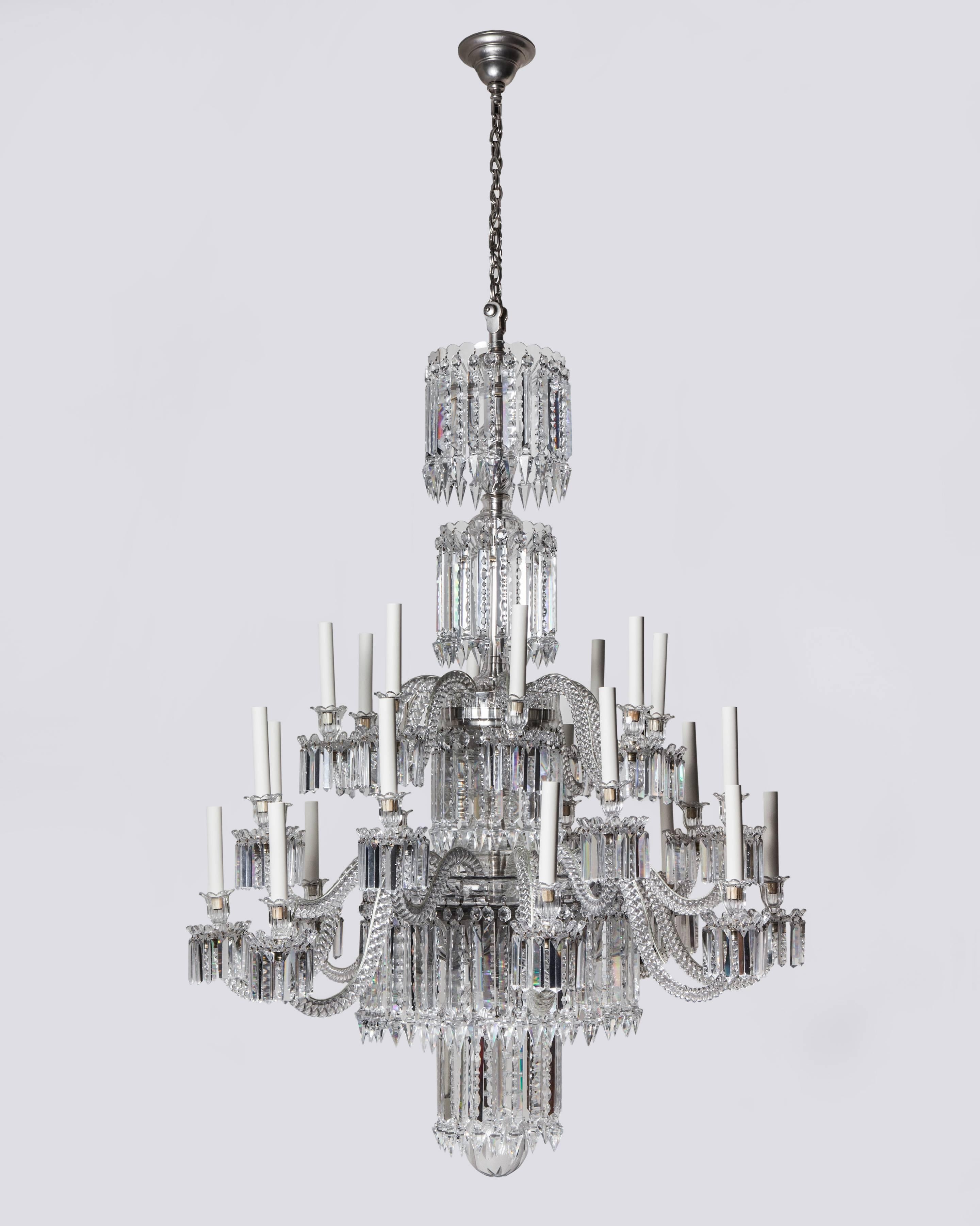 AHL3960

A twenty-four light crystal chandelier having two tiers of alternating height arms issuing from a waterfall-form body with silverplate mounts. The whole is brilliantly cut and dressed. Attributed to the French maker Baccarat. Due to the