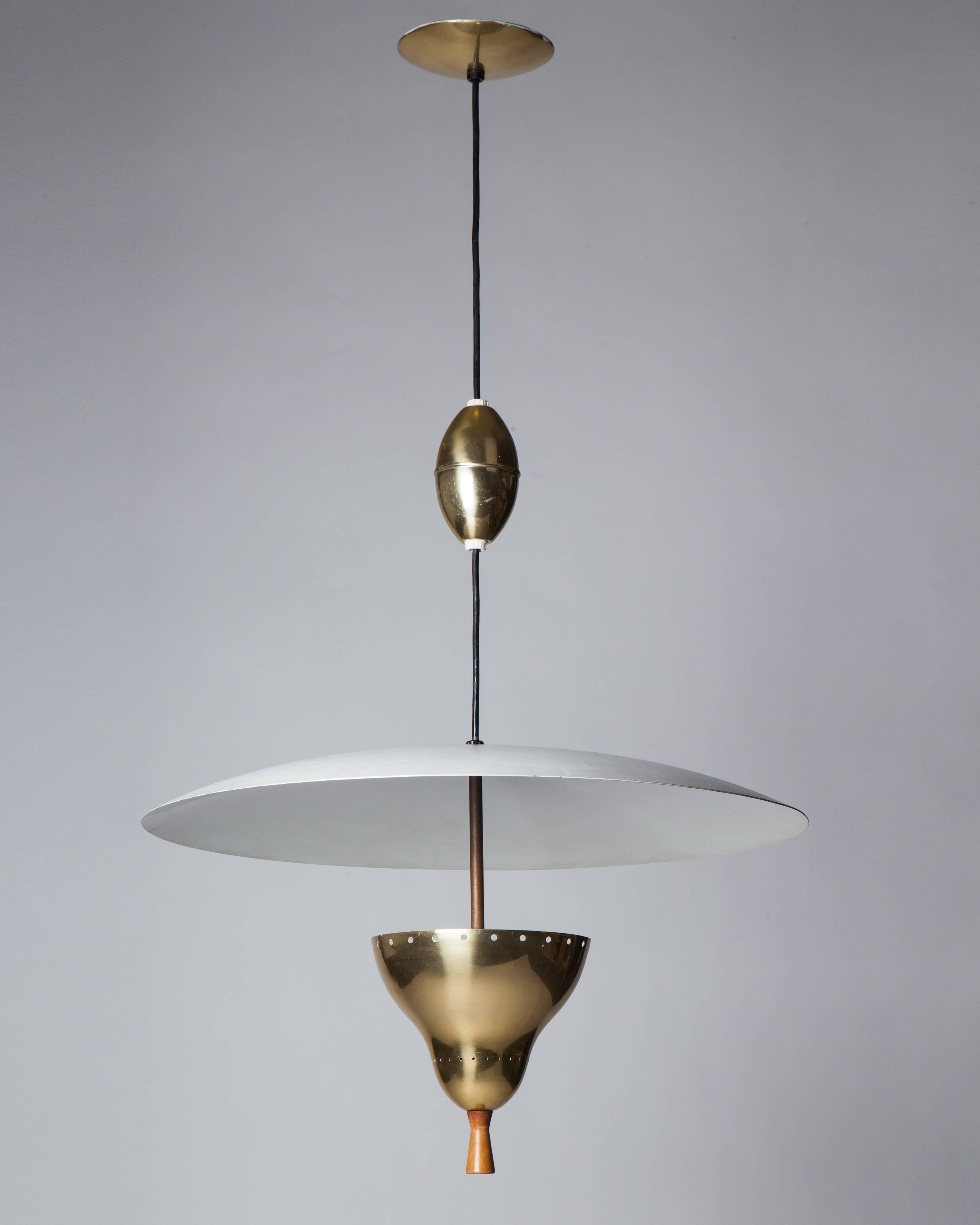 AHL3966
An anodized aluminum, brass and wood spring-loaded pulley light with a large disc shade in its original enameled white finish. The height of fixture can be extended up to an extra 24
