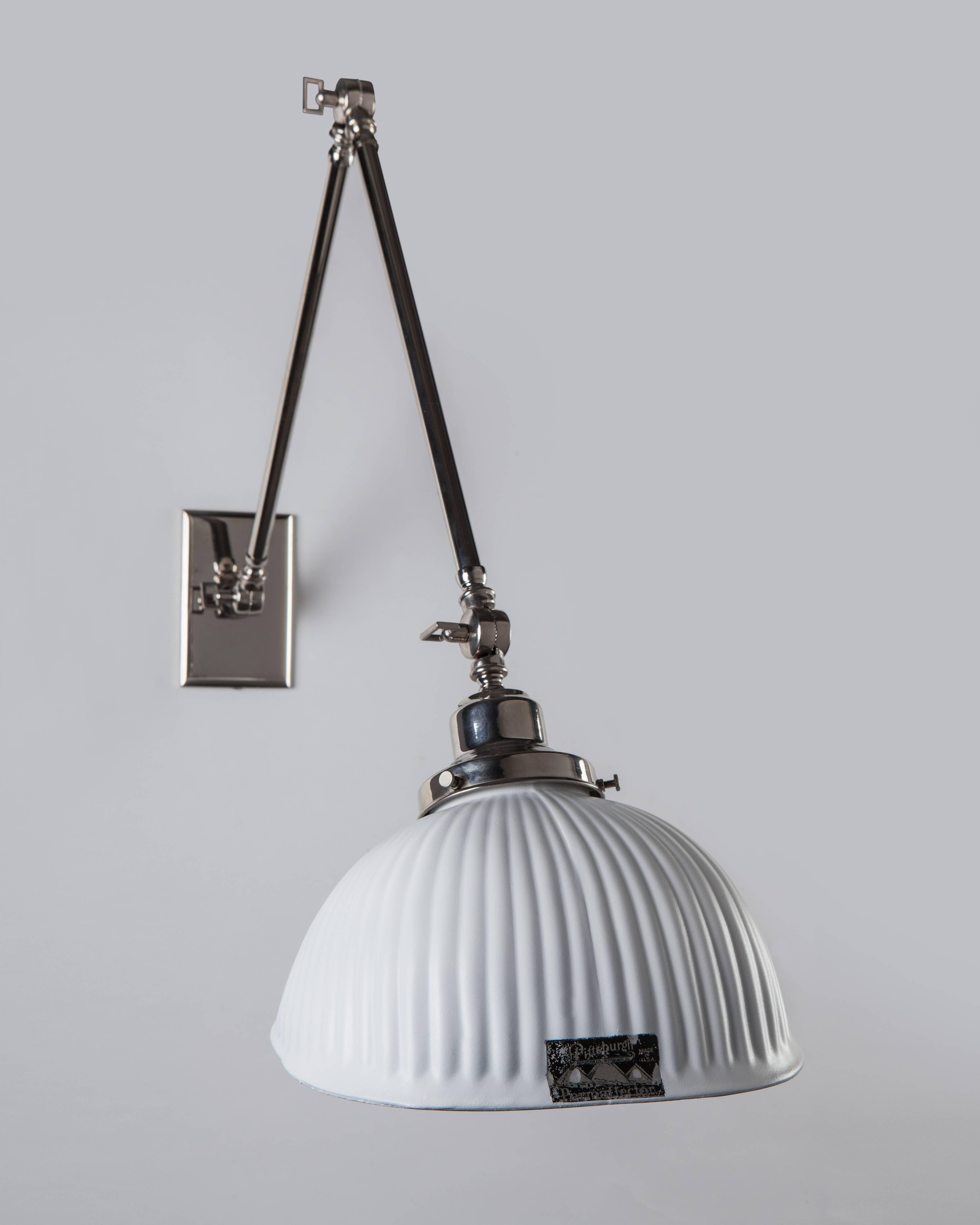 AIS2940

A long-limbed wall-mounted industrial reading lamp with a squared white lacquered mercury glass shade. On polished nickel fittings custom-made in the Remains Lighting workshop. The glass bearing the mark of the Pennsylvania maker