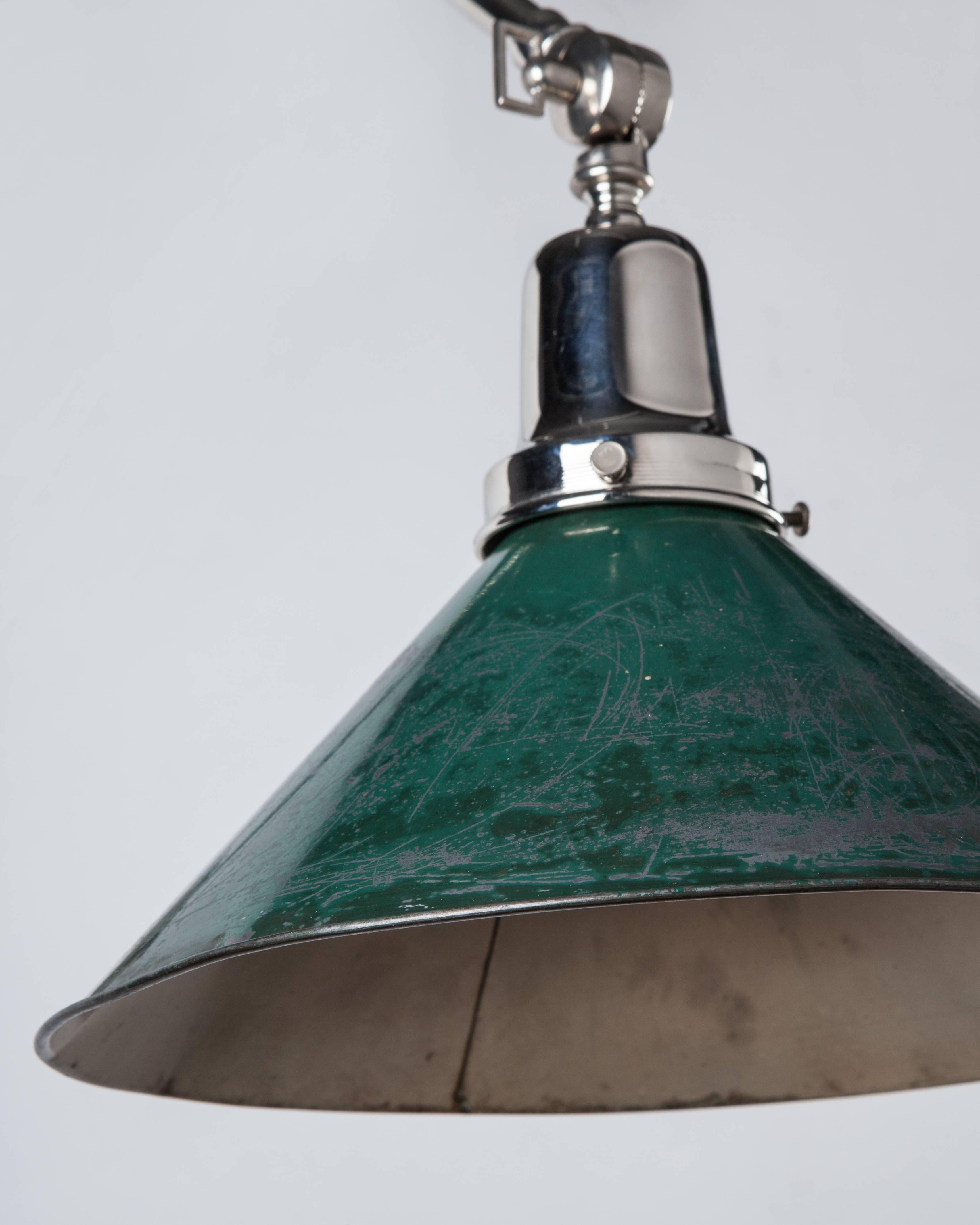 AIS2937
An articulated sconce having an industrial tin shade in its original worn painted finish. On polished nickel fittings custom-made in the Remains Lighting workshop.

Dimensions:
Overall (extended): 8-3/4