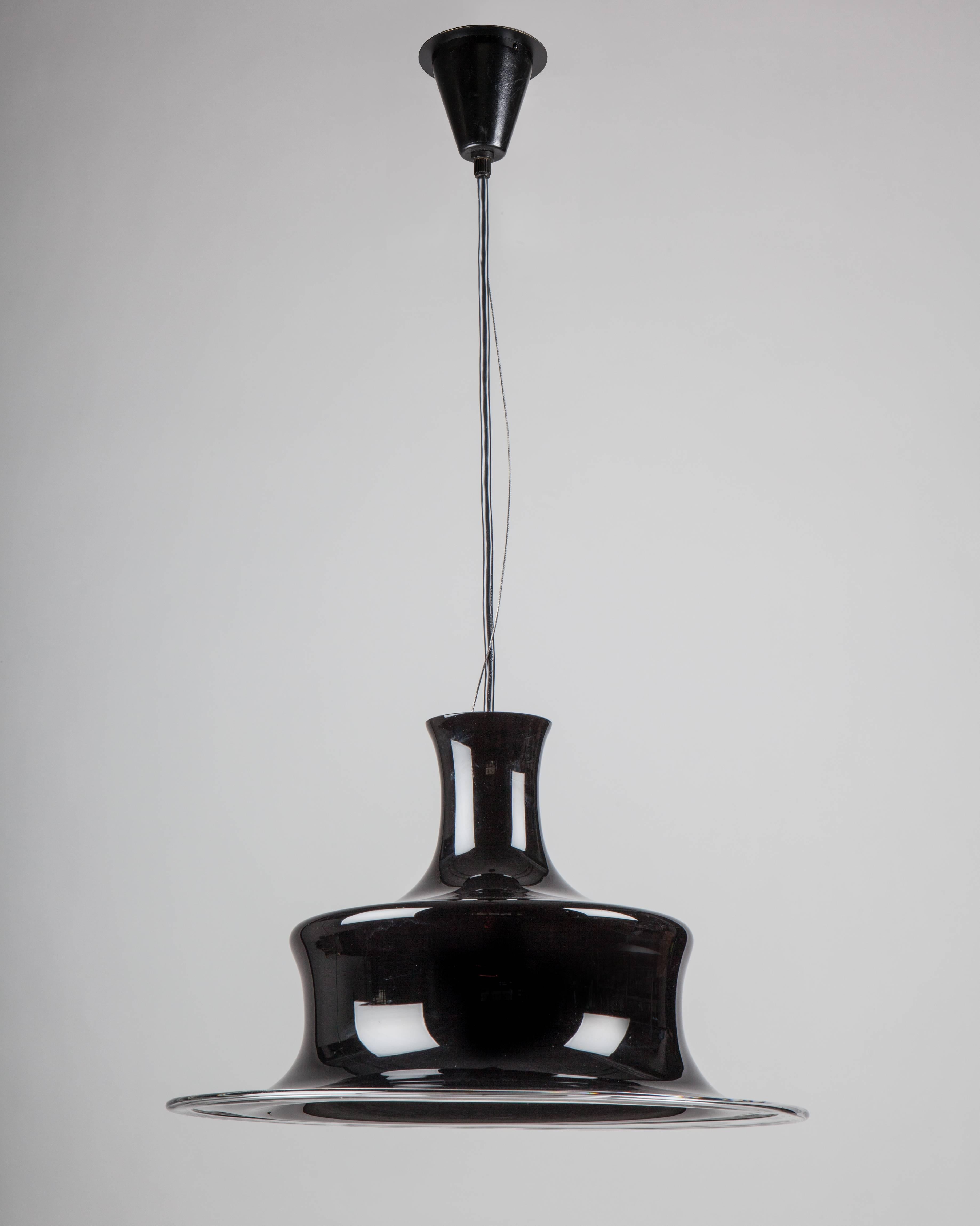 AHL3994.
A vintage pendant with dark ruby glass on its original fittings. Signed by the Danish glassmaker Holmegaard. Due to the antique nature of this fixture, there may be some nicks or imperfections in the glass as well as variations from piece