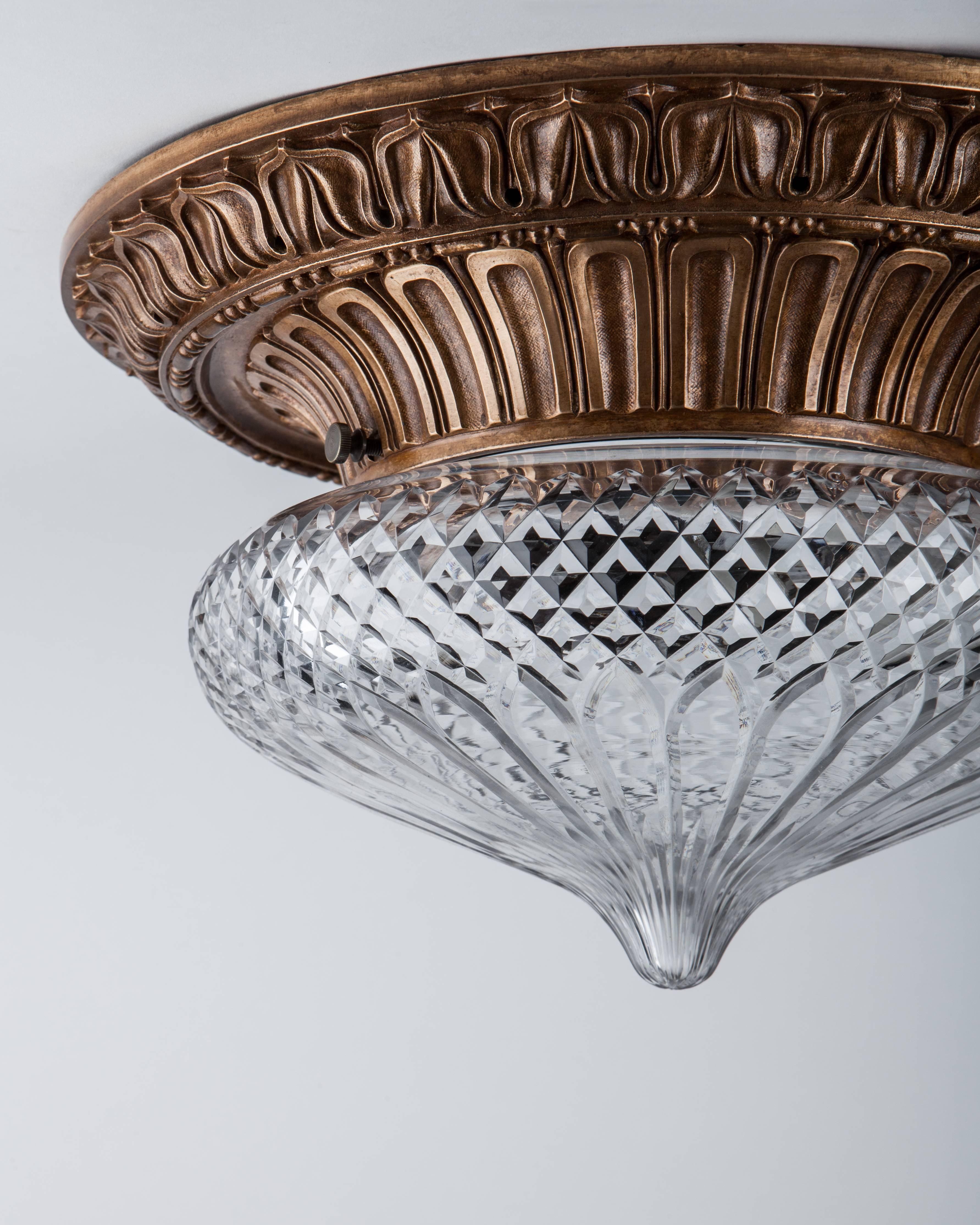 AHL3967,
a finely chased leaf-and-dart detailed bronze flush mount having a clear wheel-cut-glass shade with a diamond cross-hatched border. Signed by the New York maker E. F. Caldwell Co. Due to the antique nature of this fixture, there may be