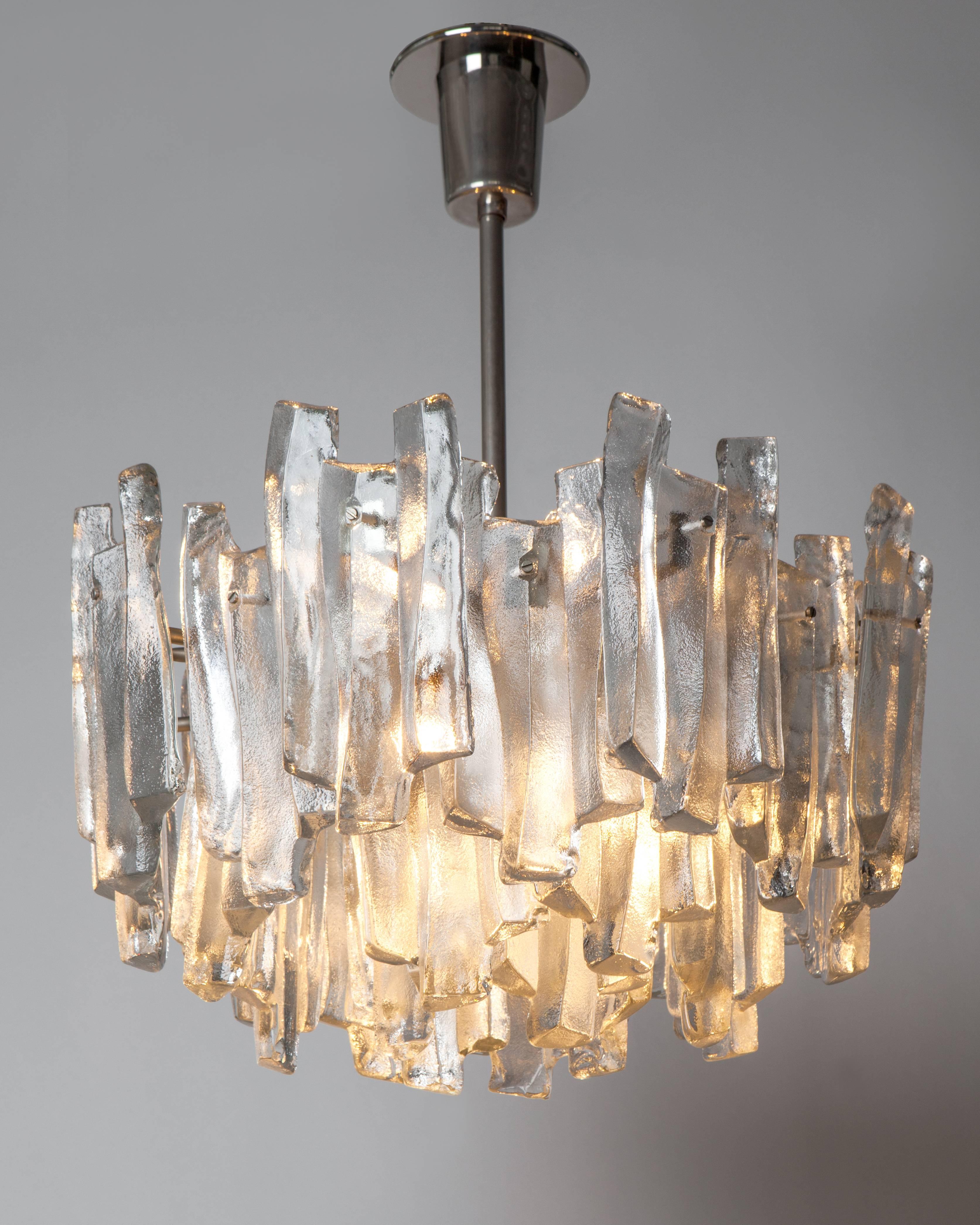 AHL3996
A vintage mid century modern chandelier with ice style glass prisms on old nickel metalwork by the Austrian maker Kalmar. Due to the antique nature of this fixture, there may be some nicks or imperfections in the