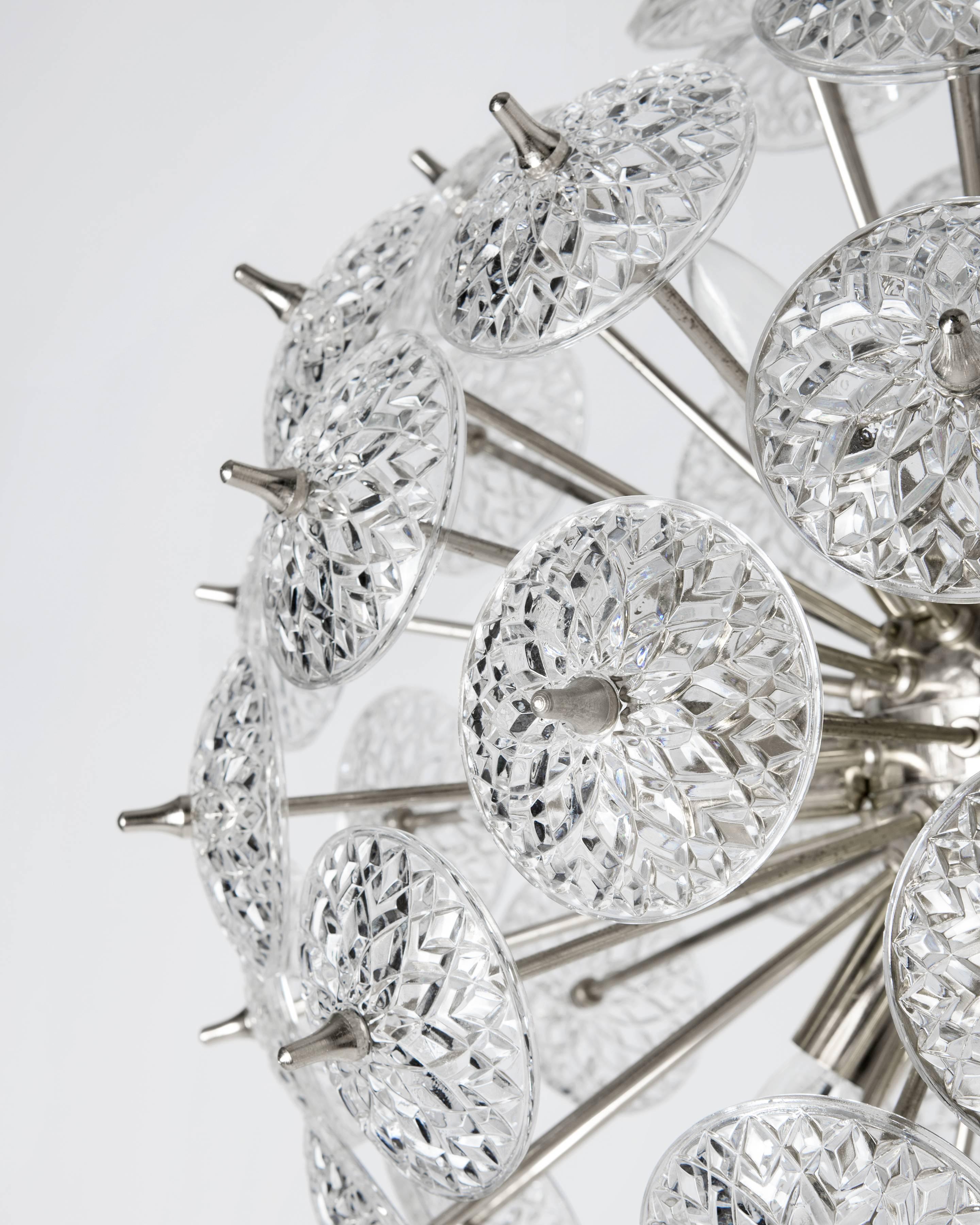 AHL3897

A vintage Sputnik chandelier with textured glass rondelles in its original nickel finish. By the Belgian maker Val Saint Lambert. Due to the antique nature of this fixture, there may be some nicks or imperfections in the glass.