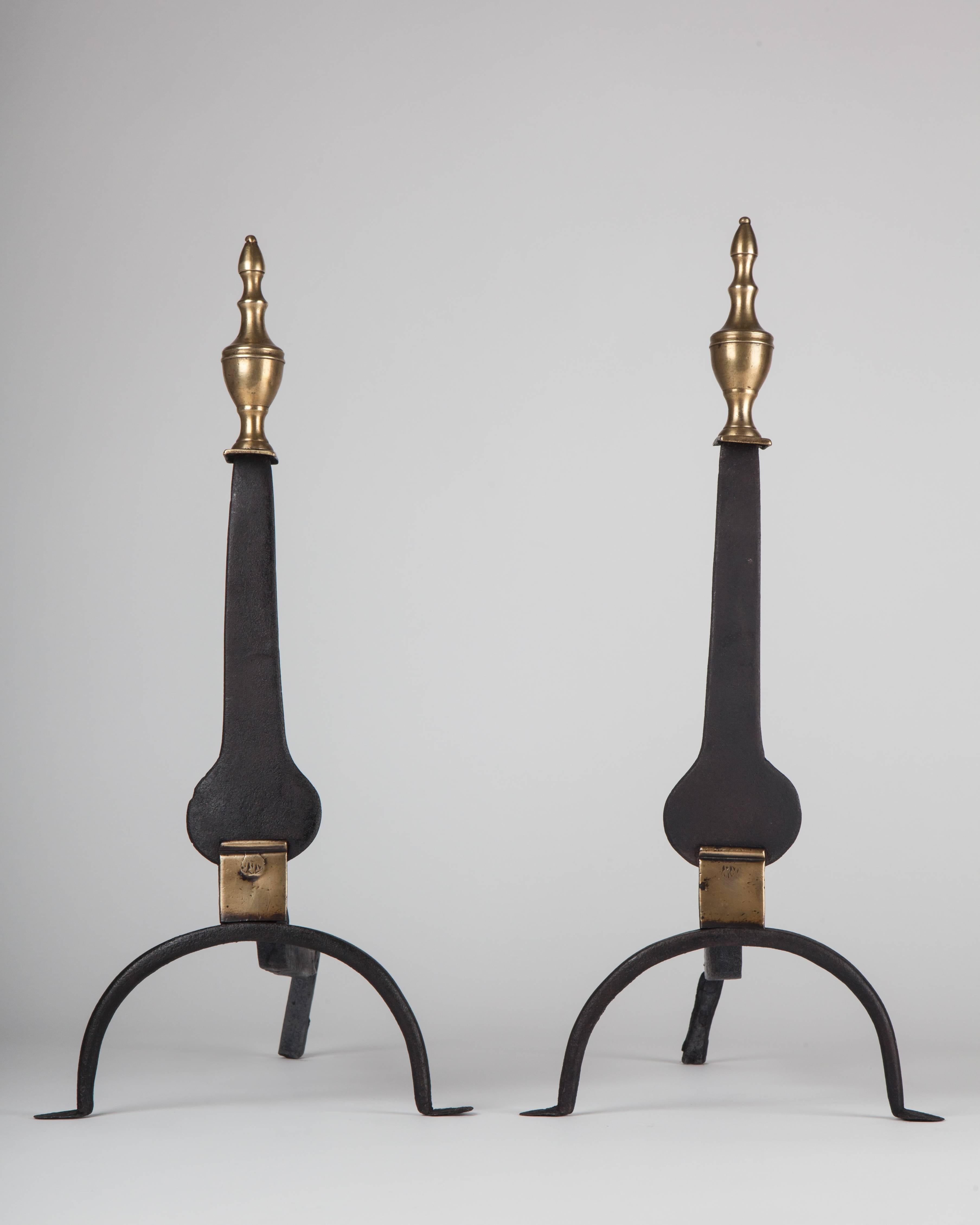 AFP0535
A pair of antique 18th century style wrought iron andirons with full round brass urn form finials and brass details atop blackened iron knife blade bodies.

Dimensions, per piece:
Overall: 20