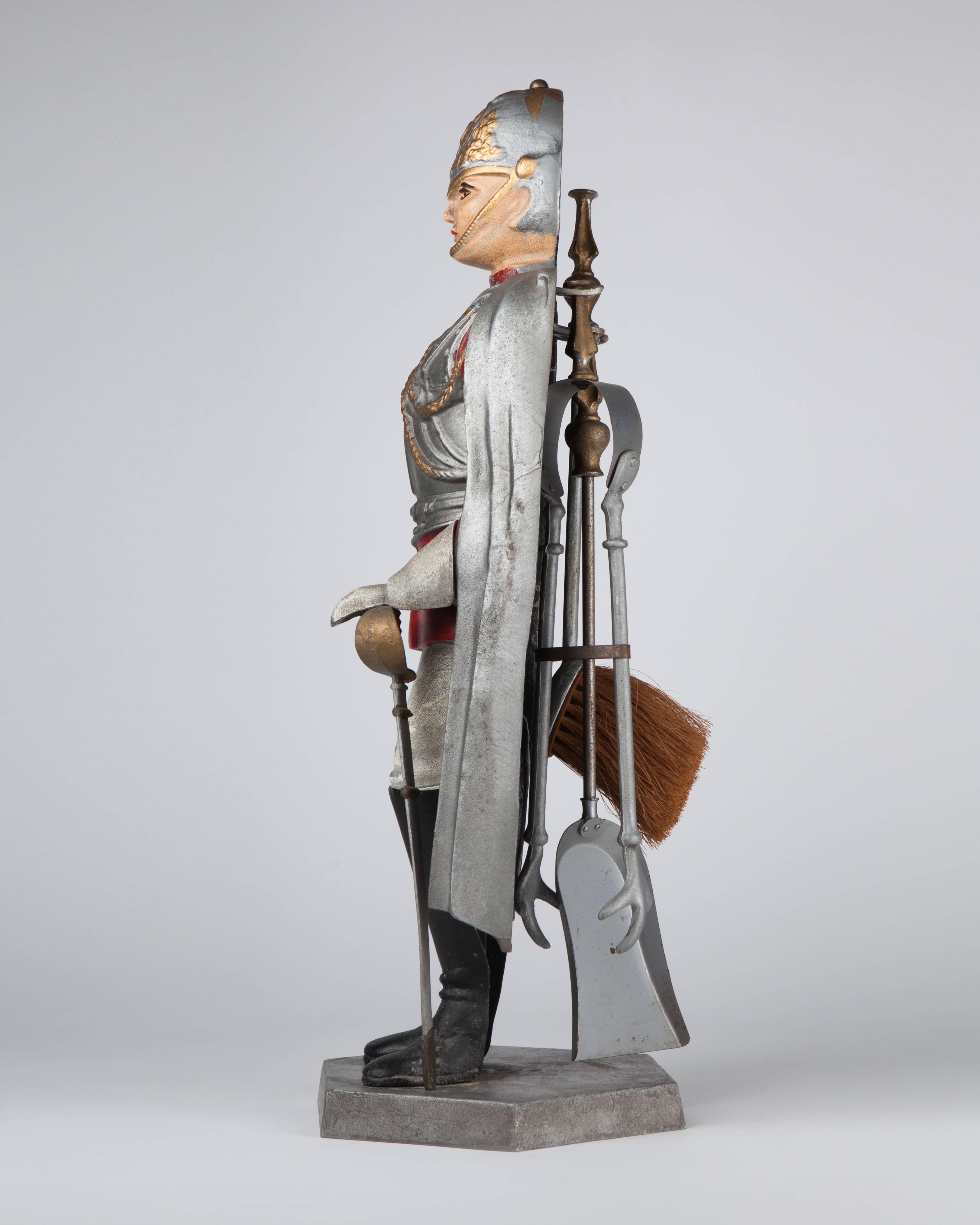 AFP0537
A cast and painted metal statue of a sentry in armor holds a classic tool set of brush, poker and tongs.

Dimensions:
Overall: 25-1/2