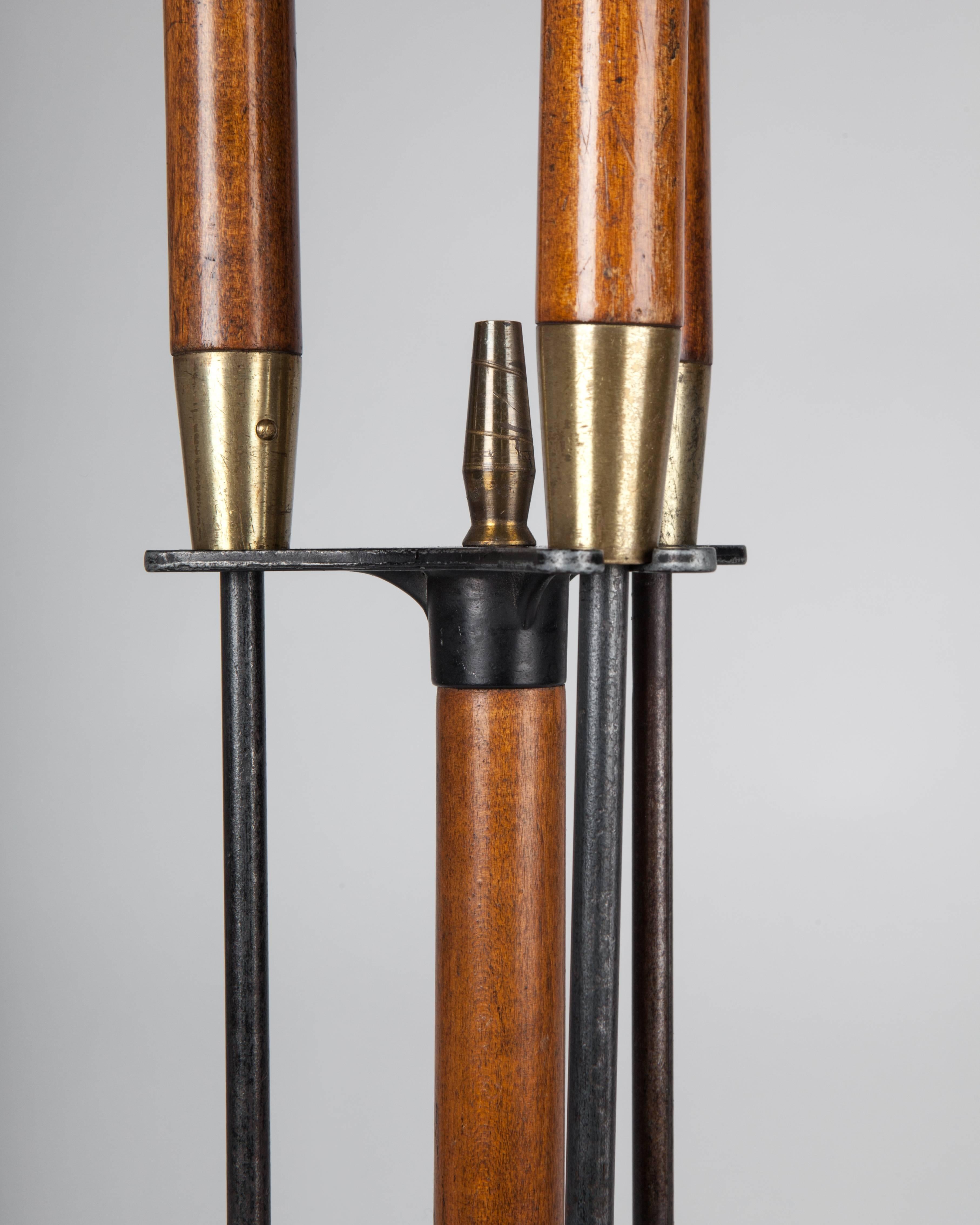 AFP0533.
A set of vintage fire tools with long wood handles, steel bodies, and brass ferrules with a matching caddy.

Dimensions:
Overall: 31-1/2