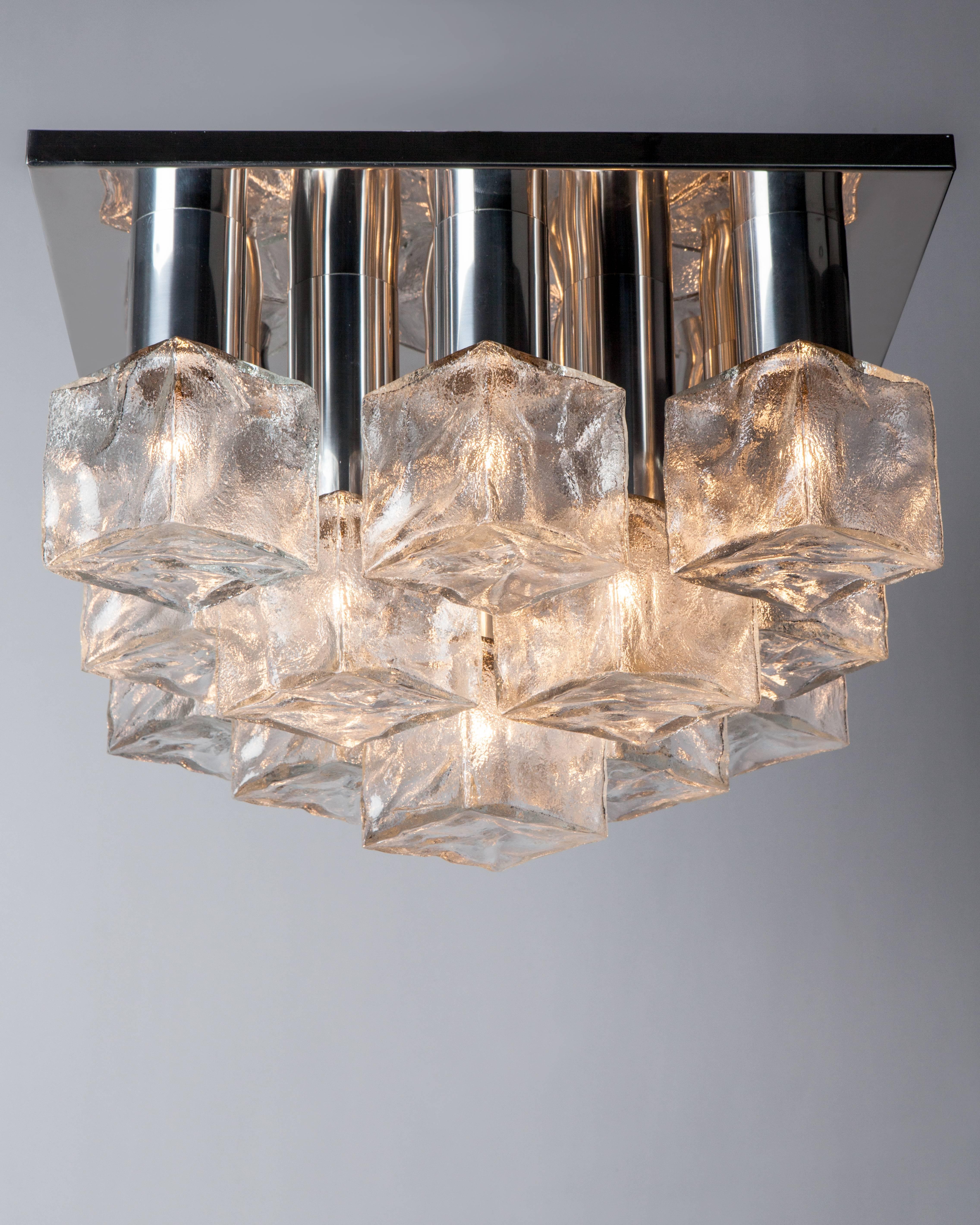 AHL4004.
A vintage flush mount with heavily textured clear cast glass cubes in its original chrome finish. Signed by the Austrian maker Kalmar. Due to the antique nature of this fixture, there may be some nicks or imperfections in the