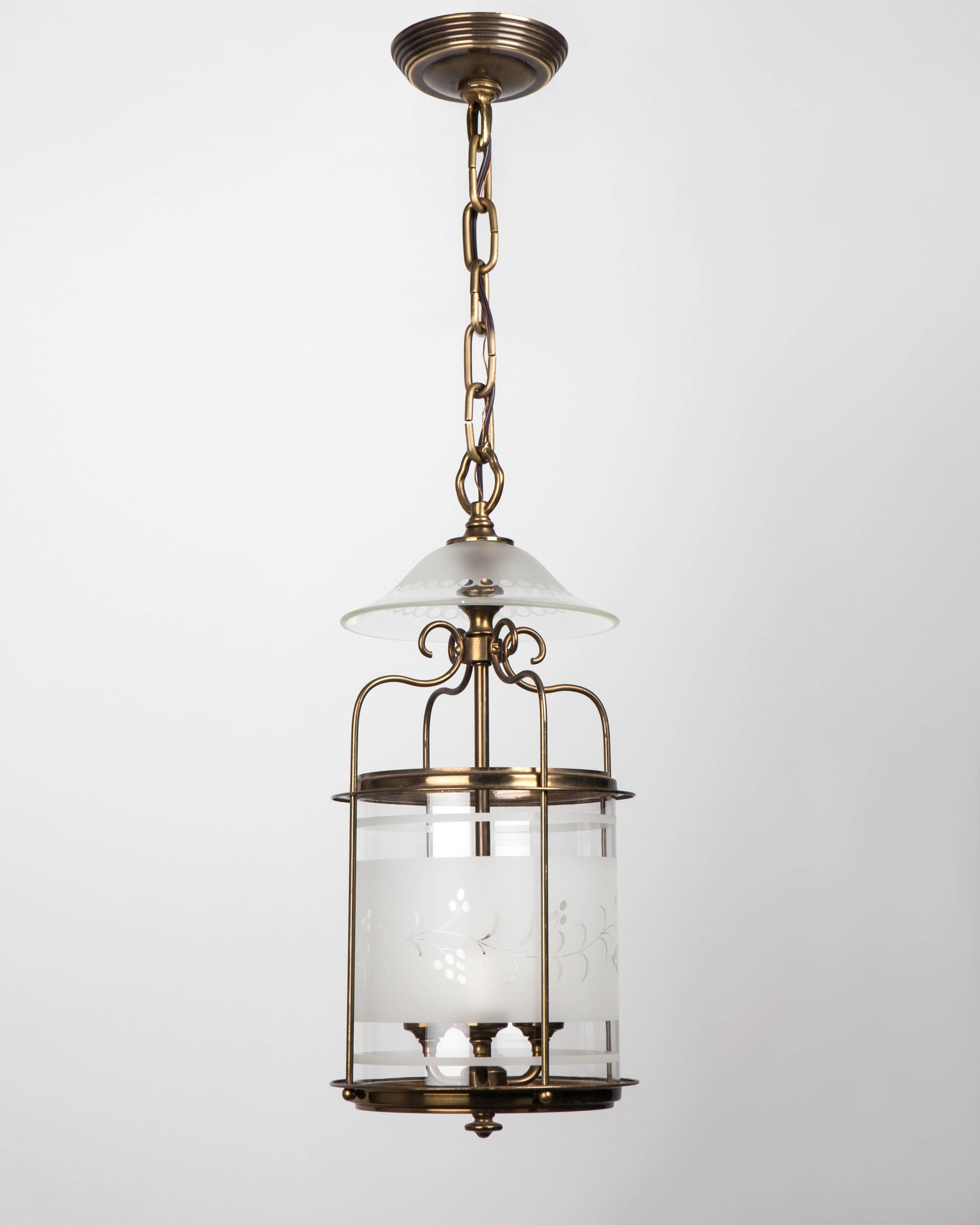 AHL4006
An antique lantern with a brass frame holding an etched and wheel-cut cylinder lens. The whole is topped by a glass smoke bell. Due to the antique nature of this fixture, there may be some nicks or imperfections in the
