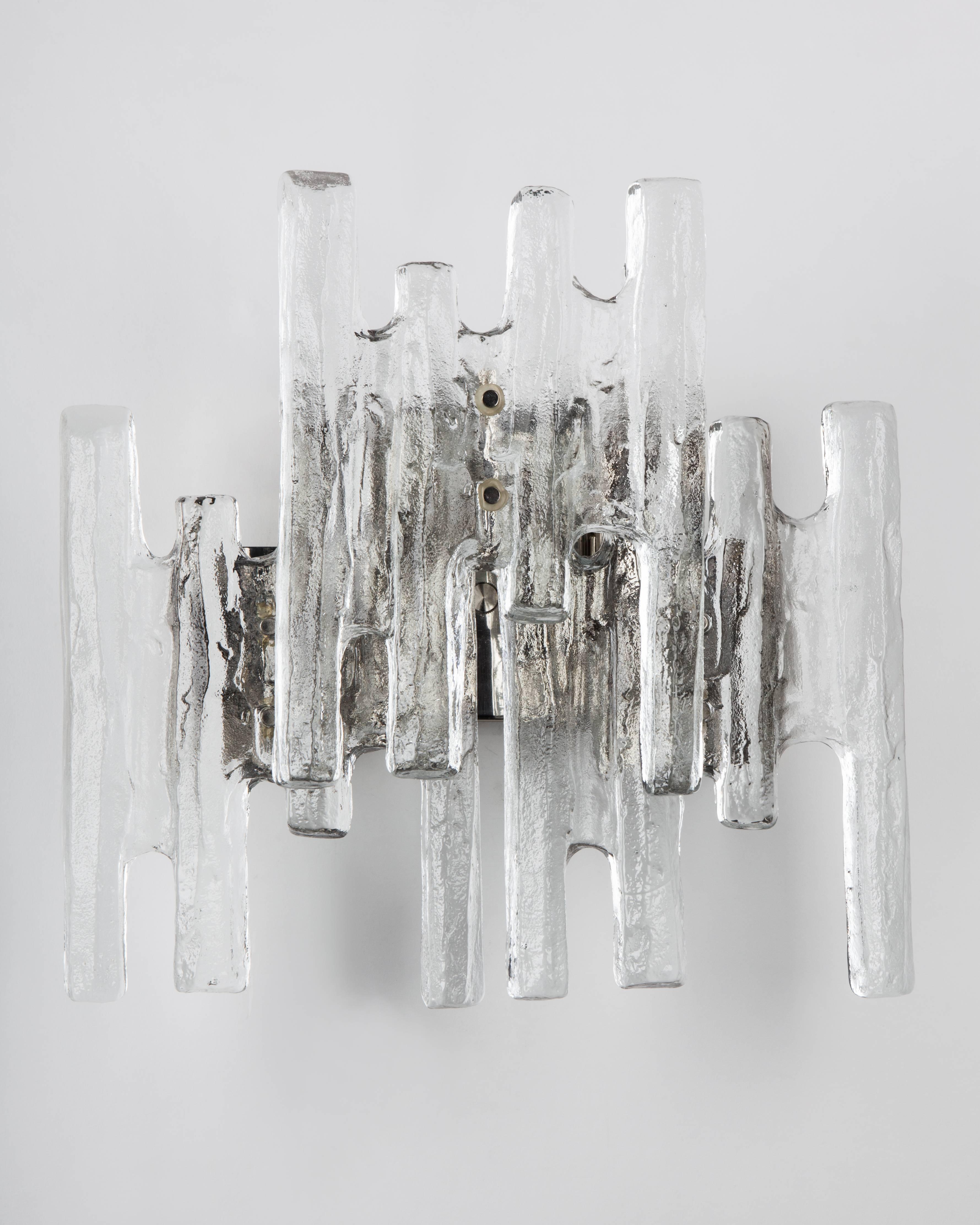 AIS2983,
a vintage sconce with three textured cast glass ice-style prisms on a nickel frame. Signed by the Austrian maker Kalmar. Due to the antique nature of this fixture, there may be some nicks or imperfections in the glass as well as variations