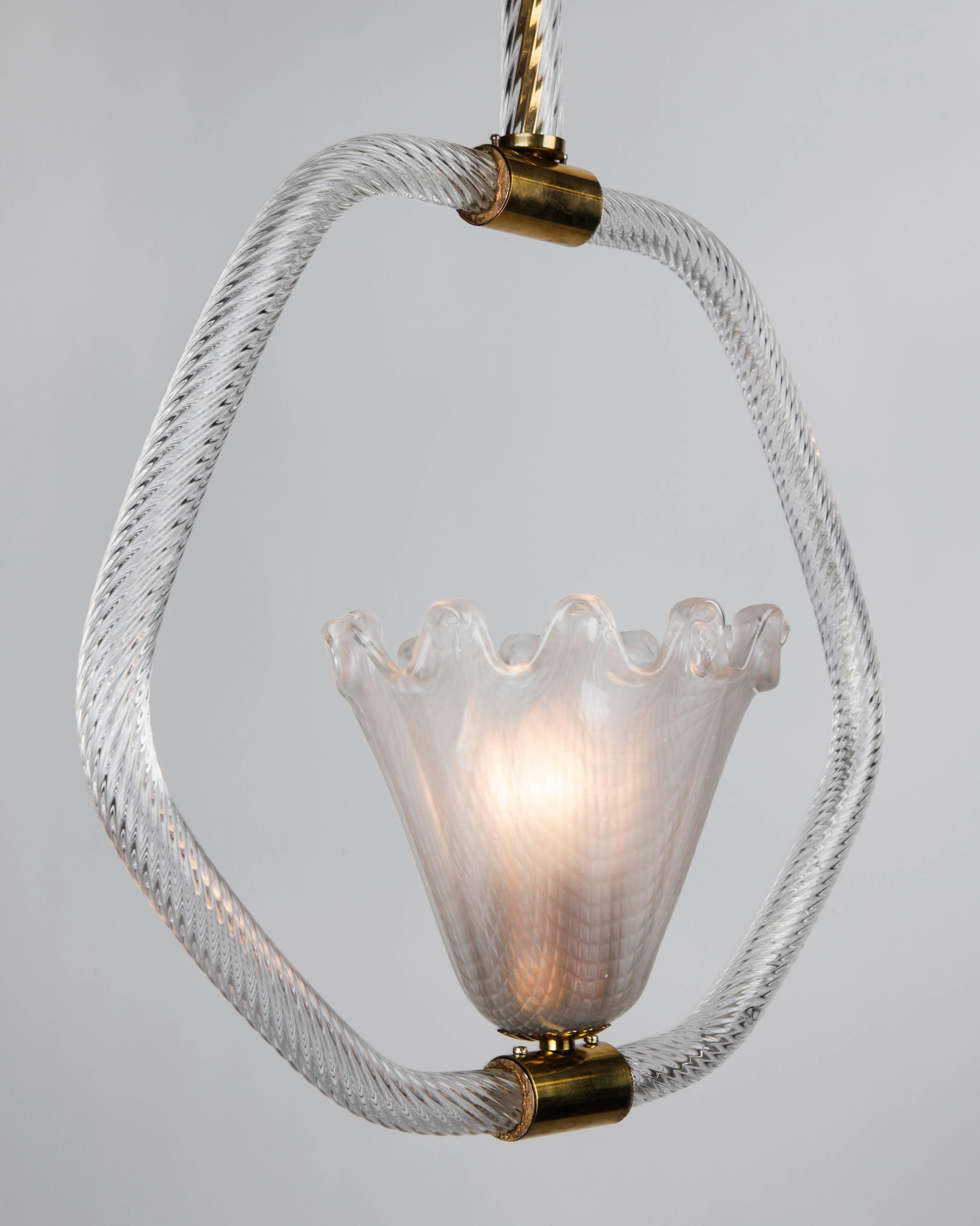 AHL4010.
A glass semi-flush mounted pendant with a rope-twist detailed hoop-form body and stem with the central element and canopy having hatch-marked textures and scalloped edges. The brass fittings in their original aged finish. By the Italian