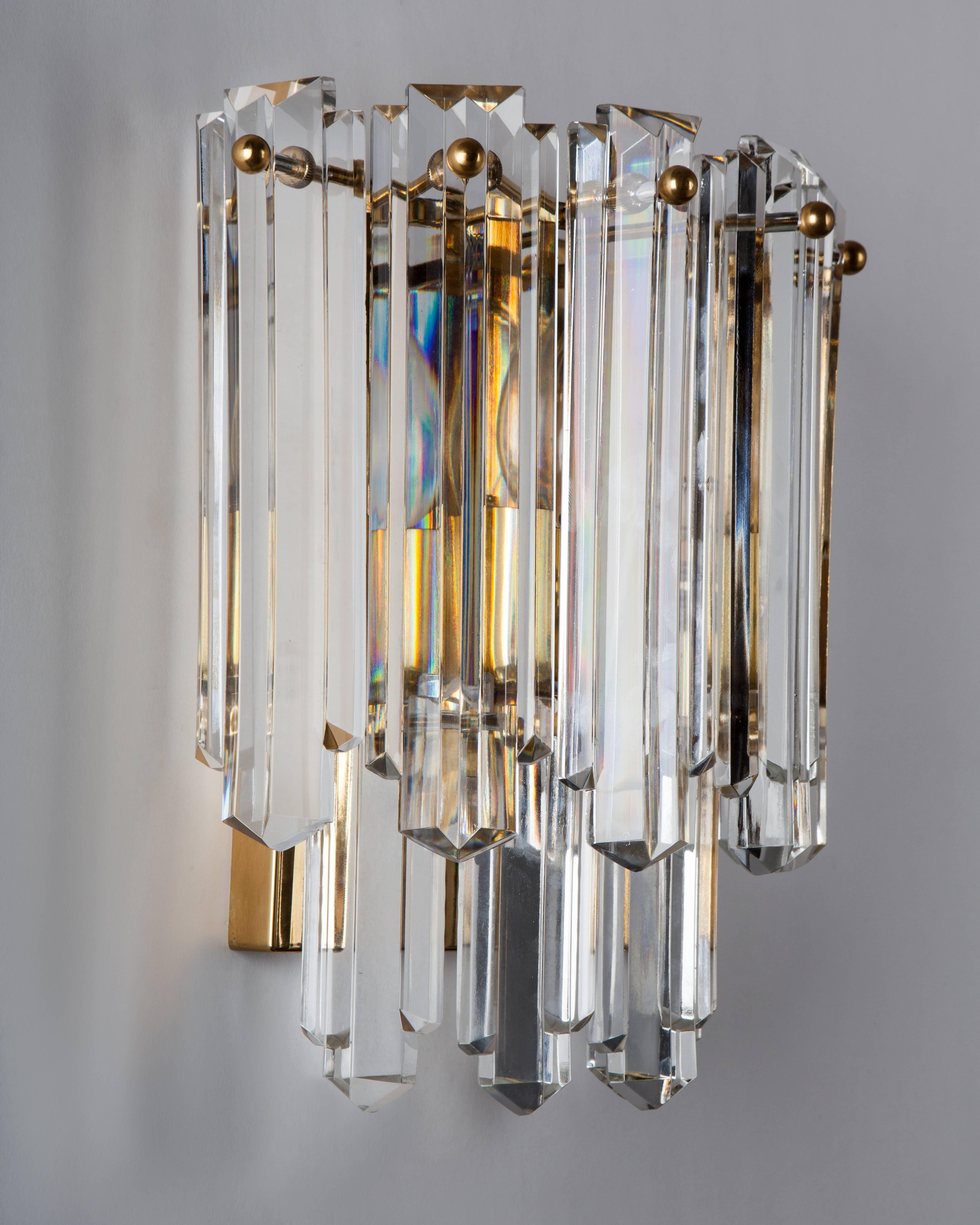 AIS2987.
A single vintage sconce with slender faceted prisms on a frame in its original gilded finish. Signed by the Austrian maker Kalmar. Due to the antique nature of this fixture, there may be some nicks or imperfections in the glass as well as