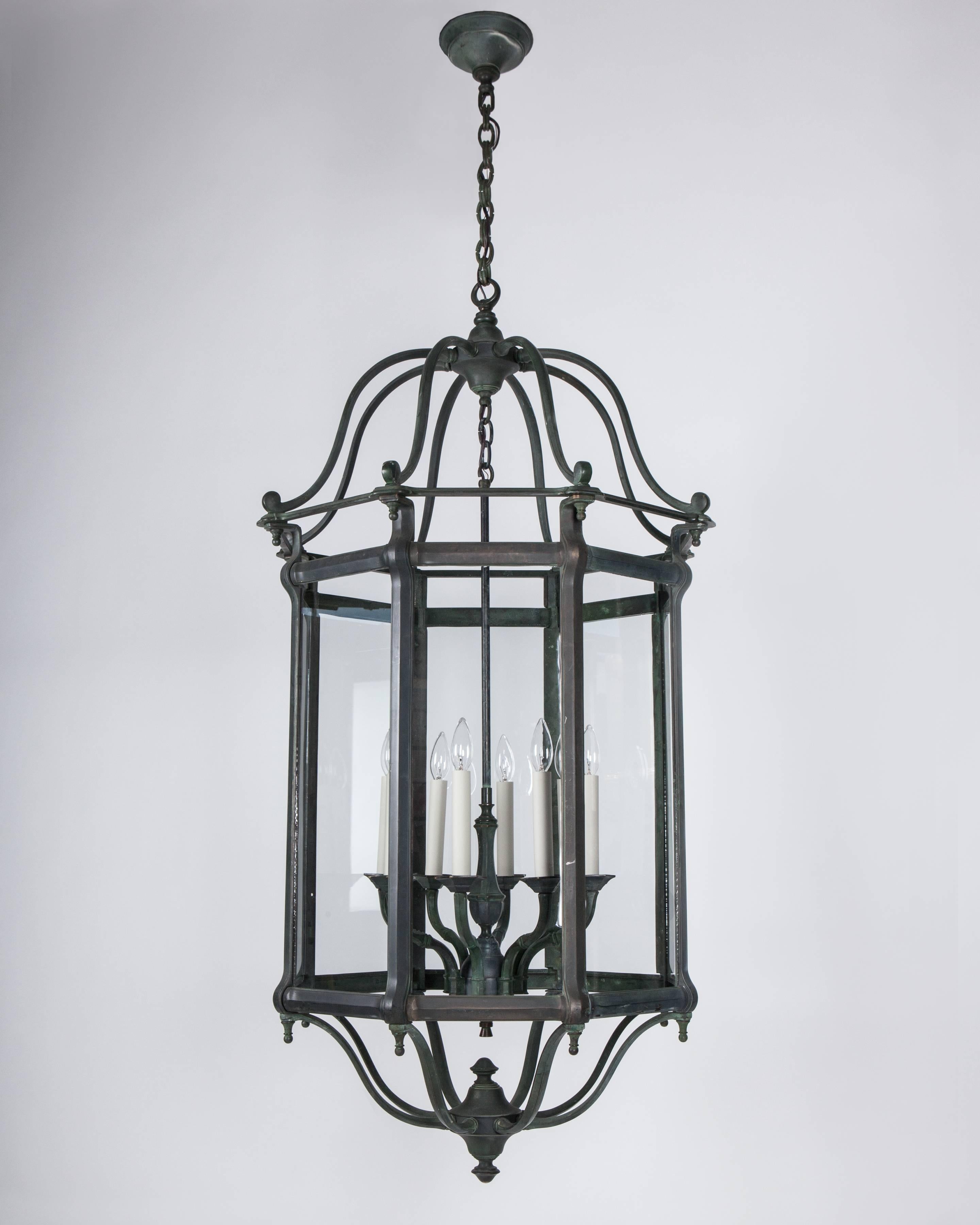 AHL4030
A large bronze octagonal lantern in its original verdigris finish with cast mullions holding clear glass panels surrounding an eight-light candelabra cluster.

Dimensions:
Current height: 123