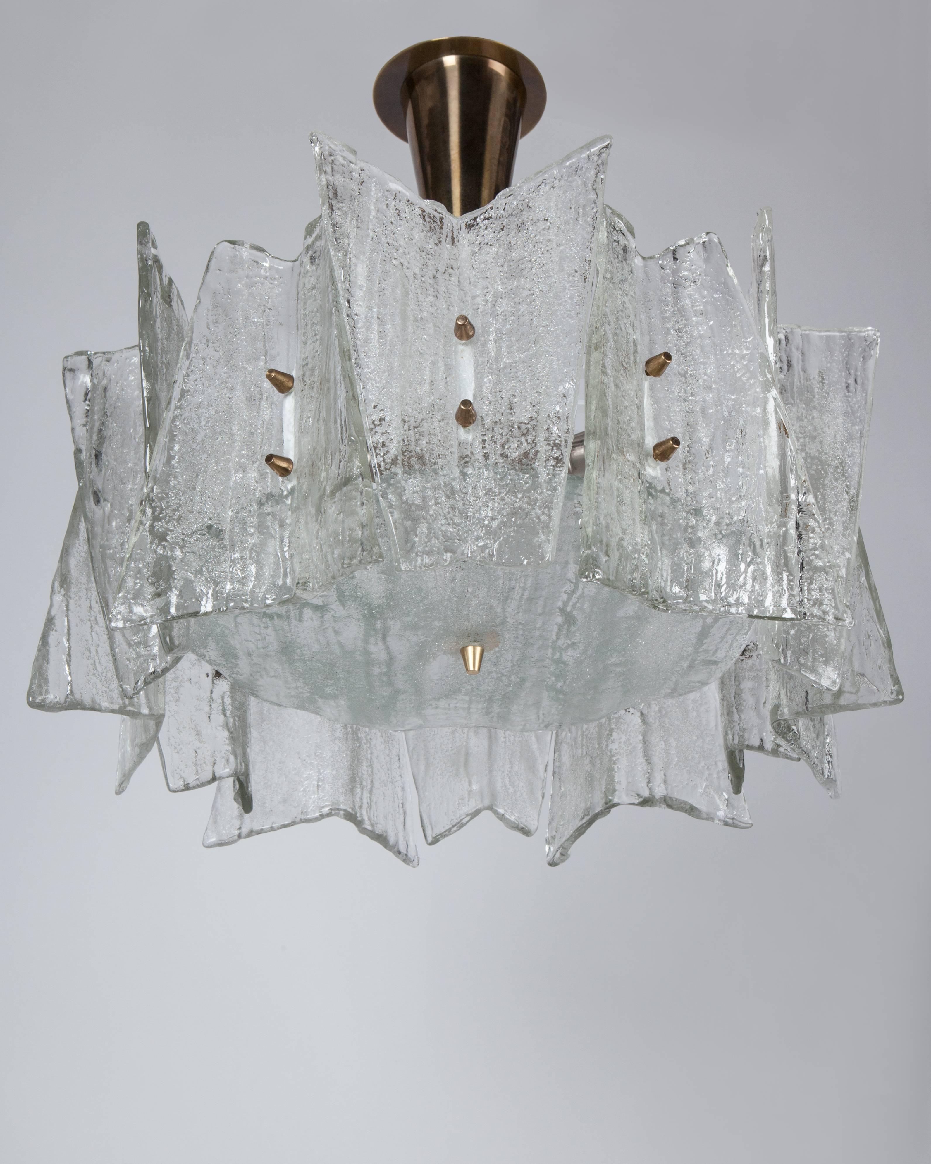 AHL4042
A vintage pendant with cast seeded glass tiles, folded into angular shapes, on a white lacquered frame with its original brass fittings. Attributed to the German maker Kaiser. Due to the antique nature of this fixture, there may be some