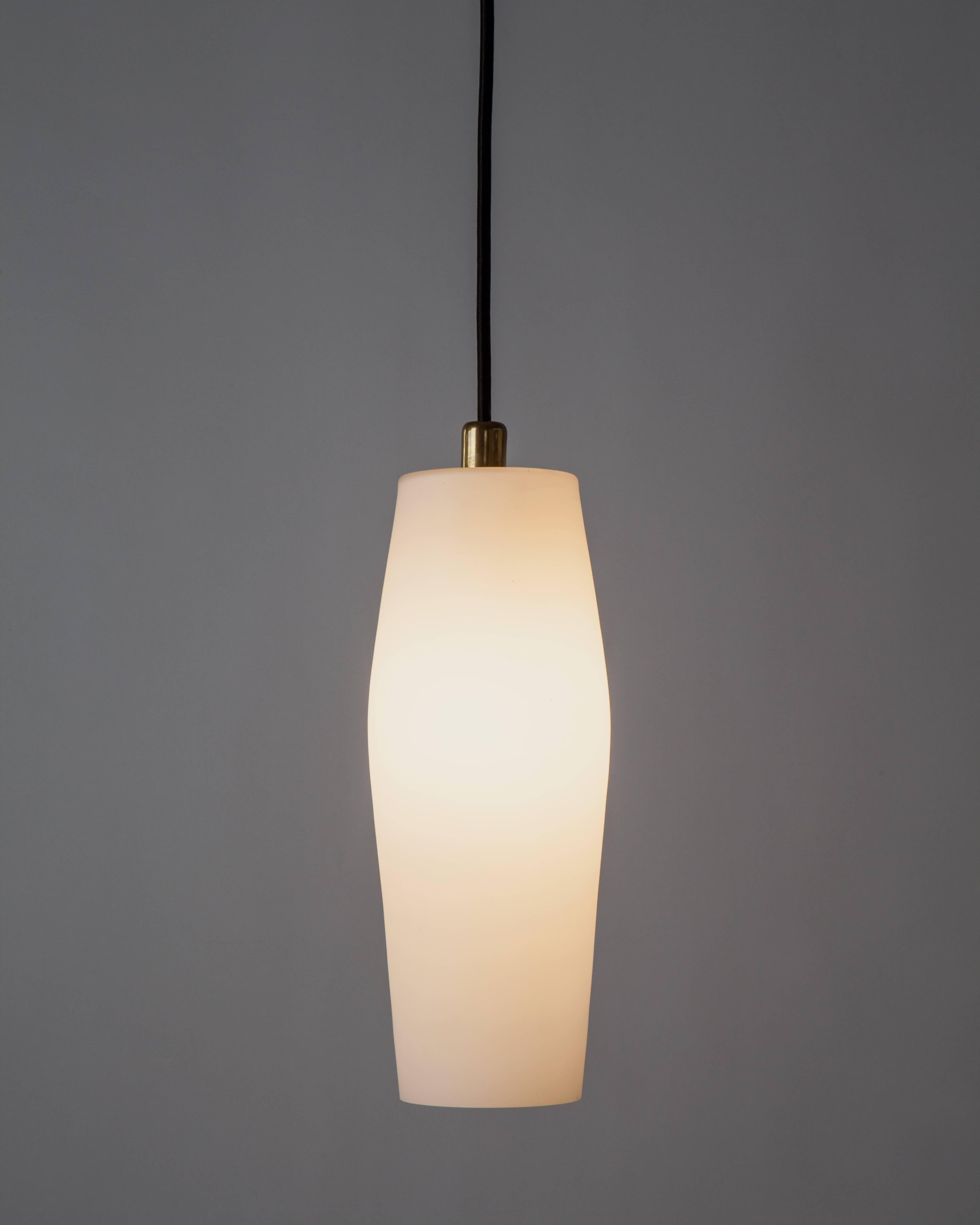 AHL4045

A Mid-Century Modern pendant having a slender urn-form frosted white glass body on its original aged brass fittings. Due to the antique nature of this fixture, there may be some nicks or imperfections in the glass as well as variations