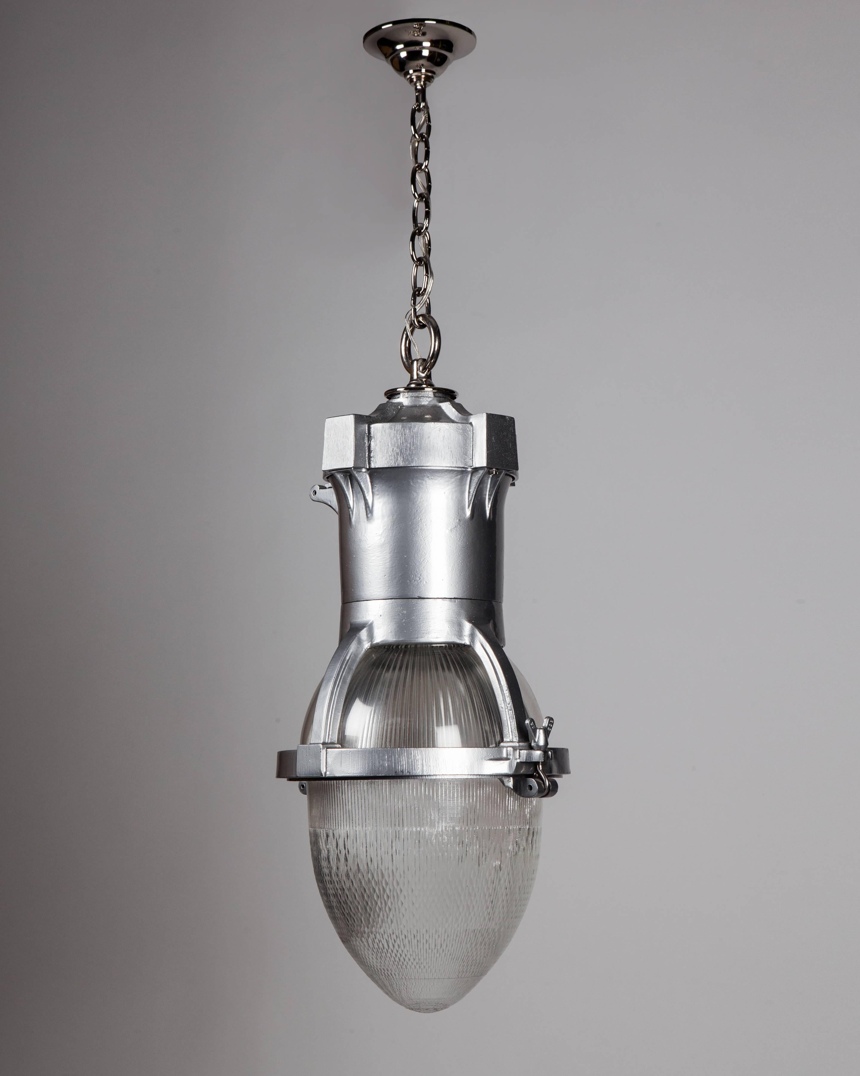 AHL4046

A vintage lantern having a two-part bullet shaped holophane glass lens and acrylic top cover in a cast aluminum frame and body, all in its original powdercoat finish. The body is suspended on polished nickel metalwork made in the Remains