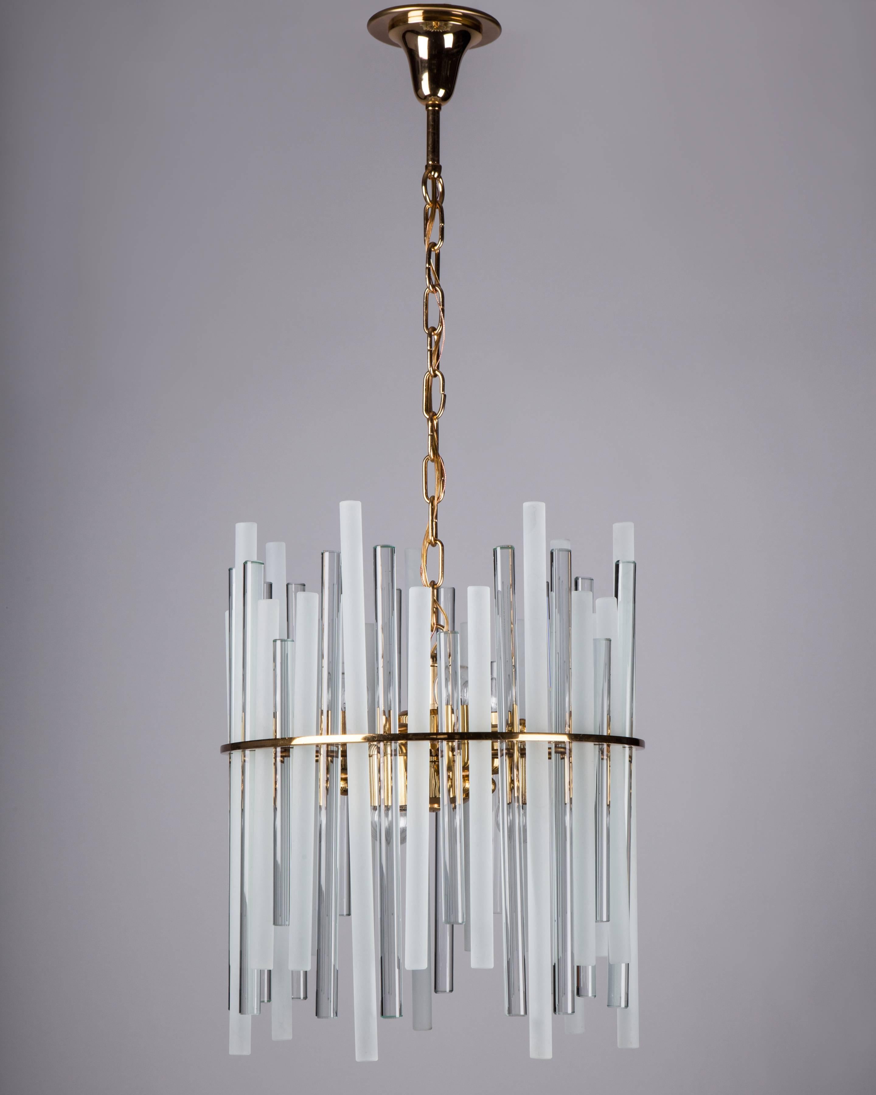 AHL4060
A vintage chandelier with frosted and clear cylindrical glass bars staggered on a gilded brass frame. Attributed to the German maker Christoph Palme. Due to the antique nature of this fixture, there may be some nicks or imperfections in the