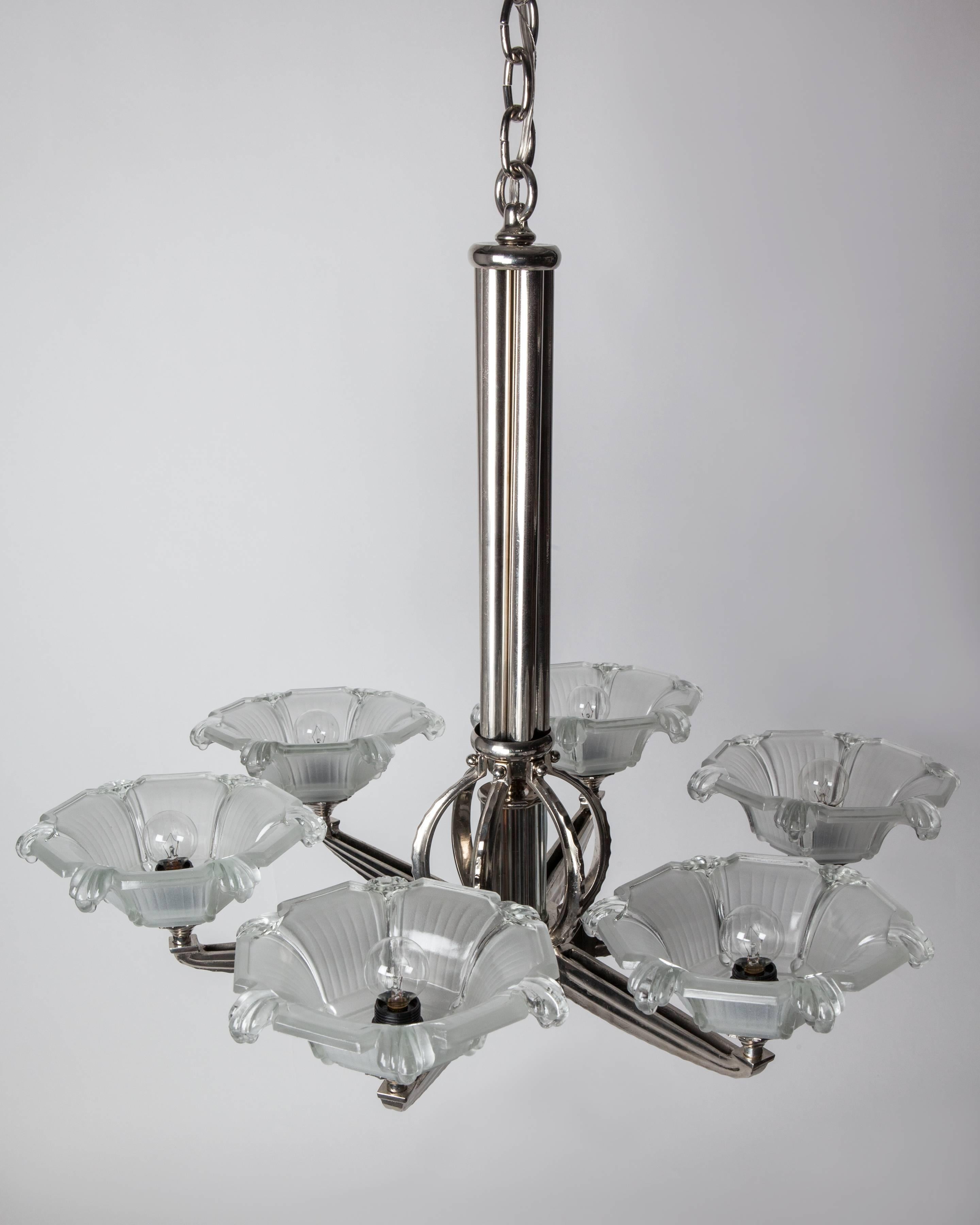 AHL4065
A vintage six-light German chandelier with a reeded nickel and glass rod body, fluted arms, and frosted floral glass shades. In a polished nickel finish. Due to the antique nature of this fixture, there may be some nicks or imperfections in