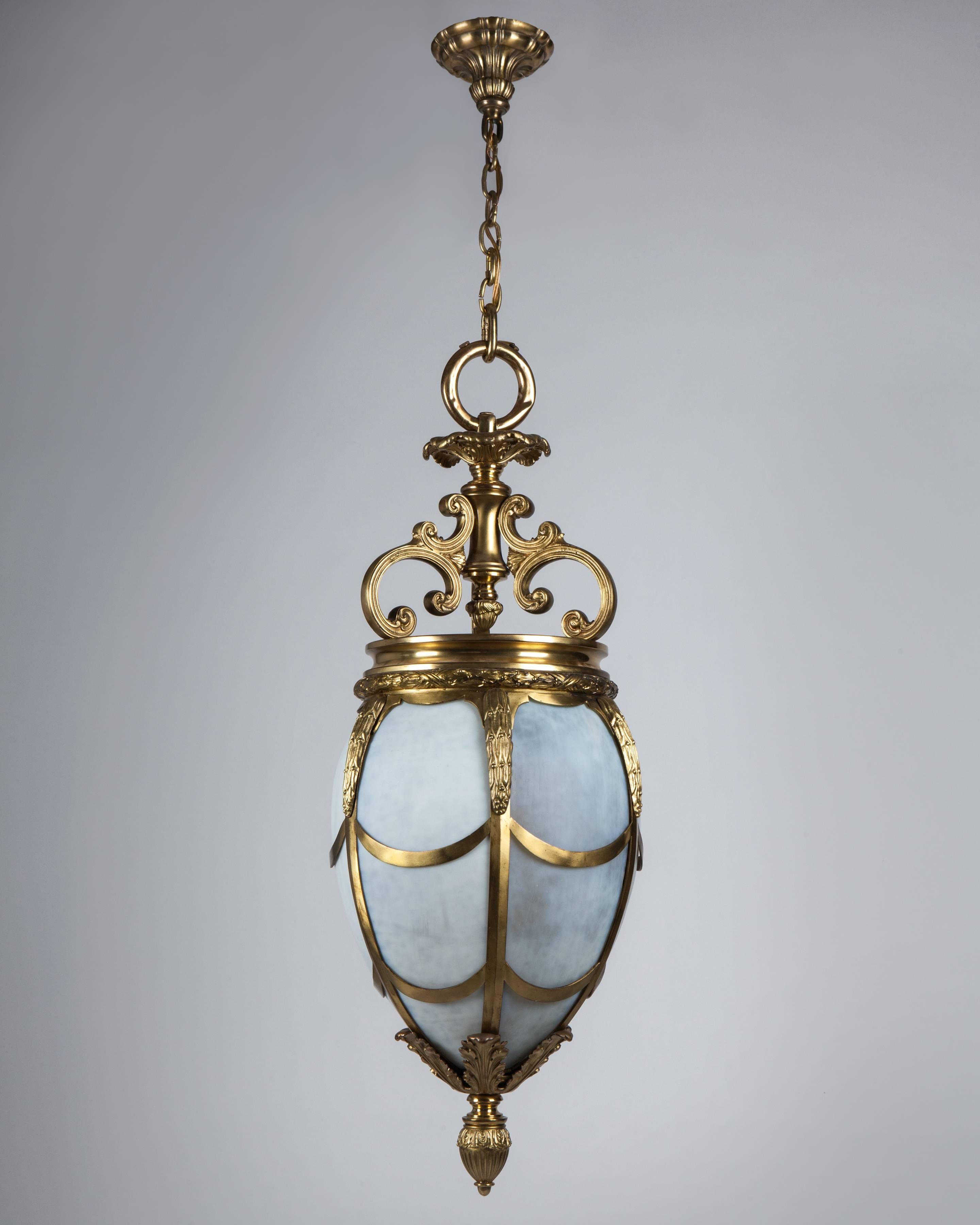 AHL4067
An antique gilded bronze oval pendant with detailed leaf decoration, glazed with its original curved frosted glass. Attributed to the Boston, Massachusetts maker Pettingell Andrews Co. Circa 1890.

Dimensions:
Current height: 52