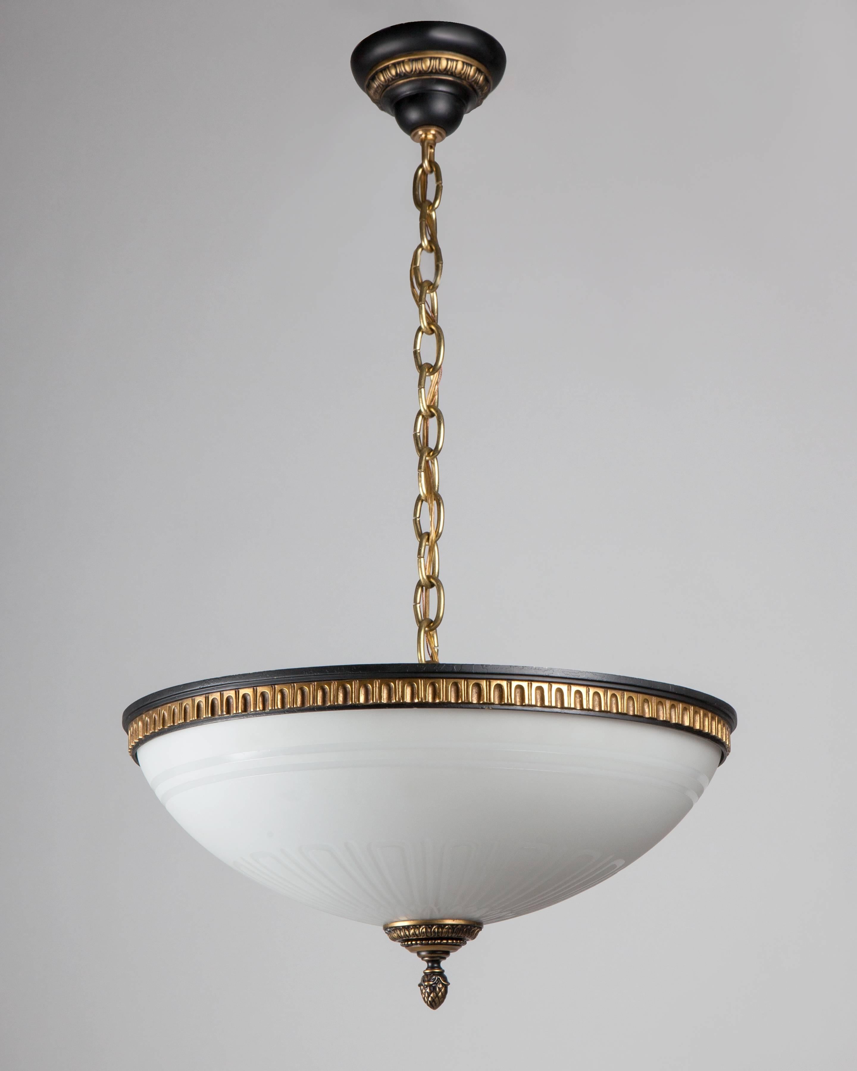 AHL4087
An antique inverted dome chandelier with an acid-etched white lens held by cast bronze fittings in their original gilded and black lacquered finish. Attributed to the New York maker E. F. Caldwell Co. Due to the antique nature of this