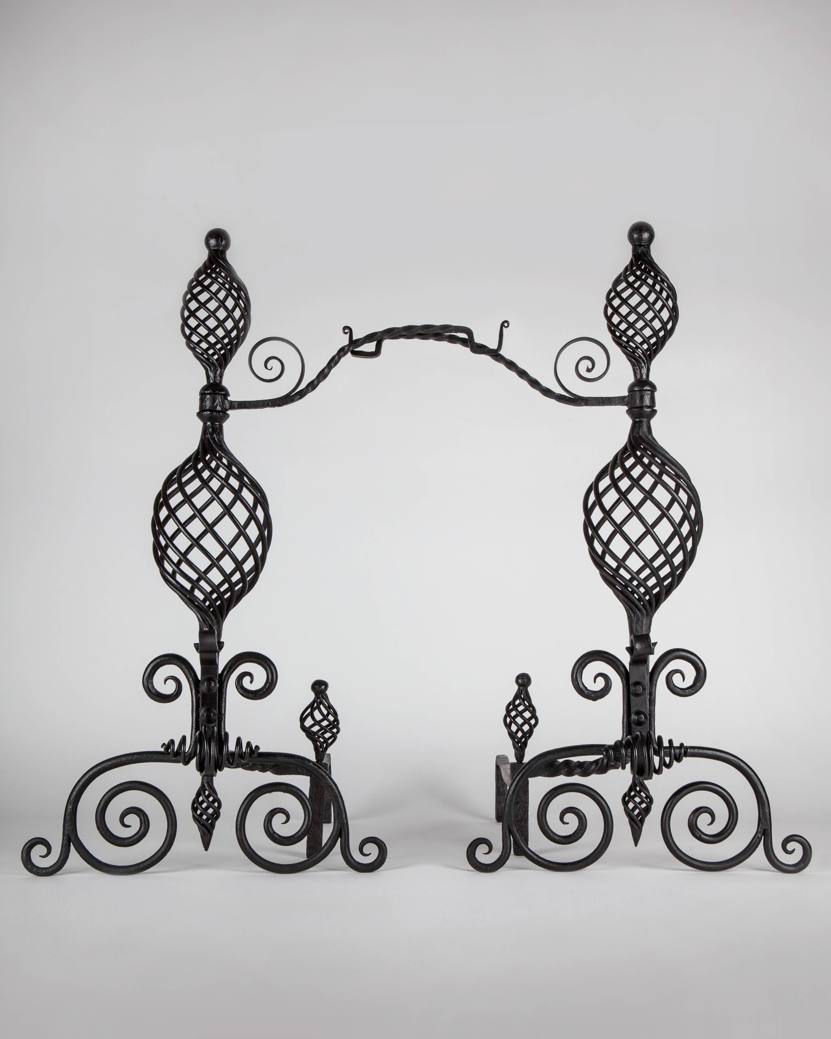 AFP0588
A pair of antique andirons in blackened wrought iron with delicate basket twist bodies and scroll feet. Retaining their original pivoting pot hooks. From a Western Connecticut estate.

Dimensions:
Overall: 29-1/2